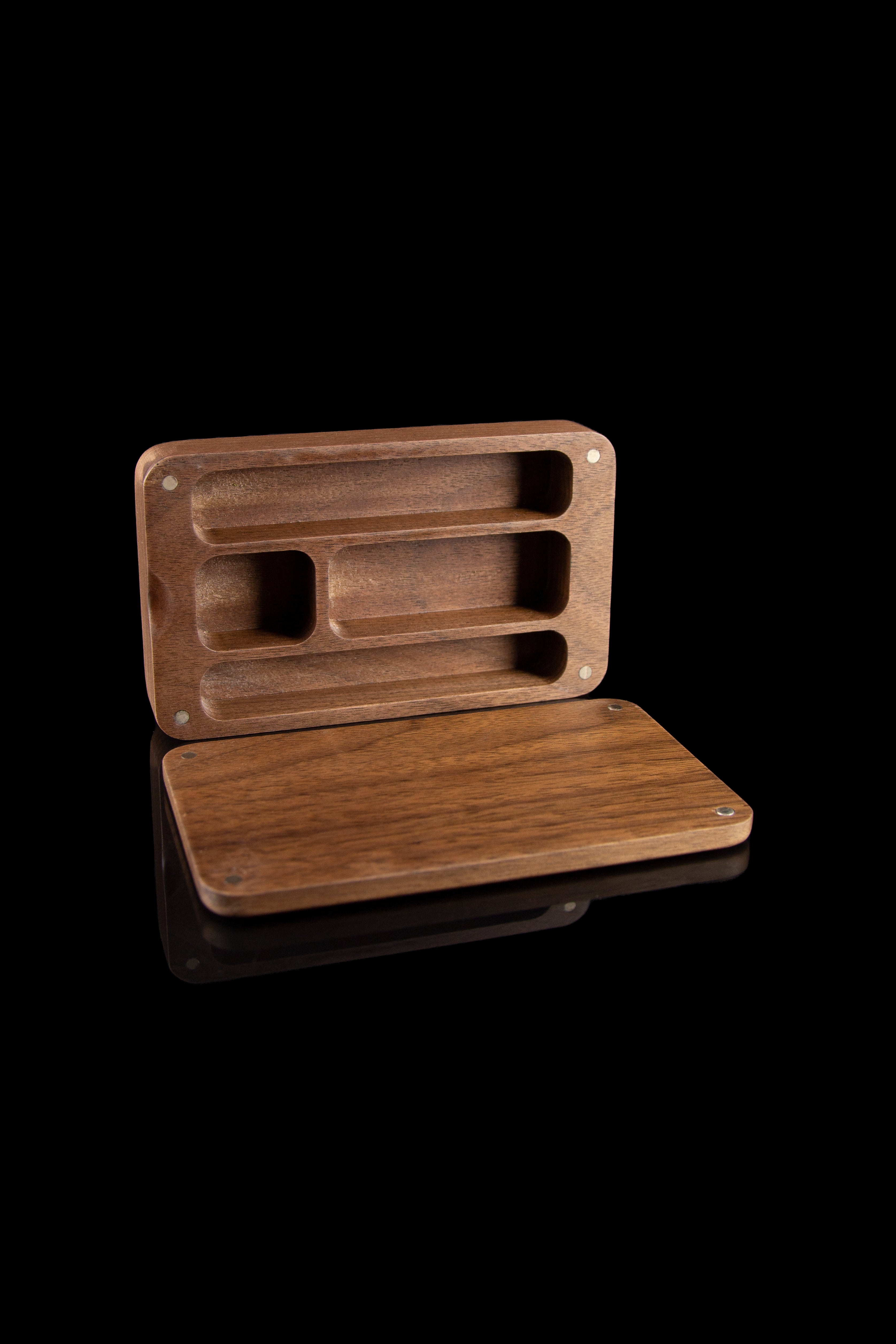 Wooden cannabis rolling box with compartments, displayed on a reflective surface against a black background.