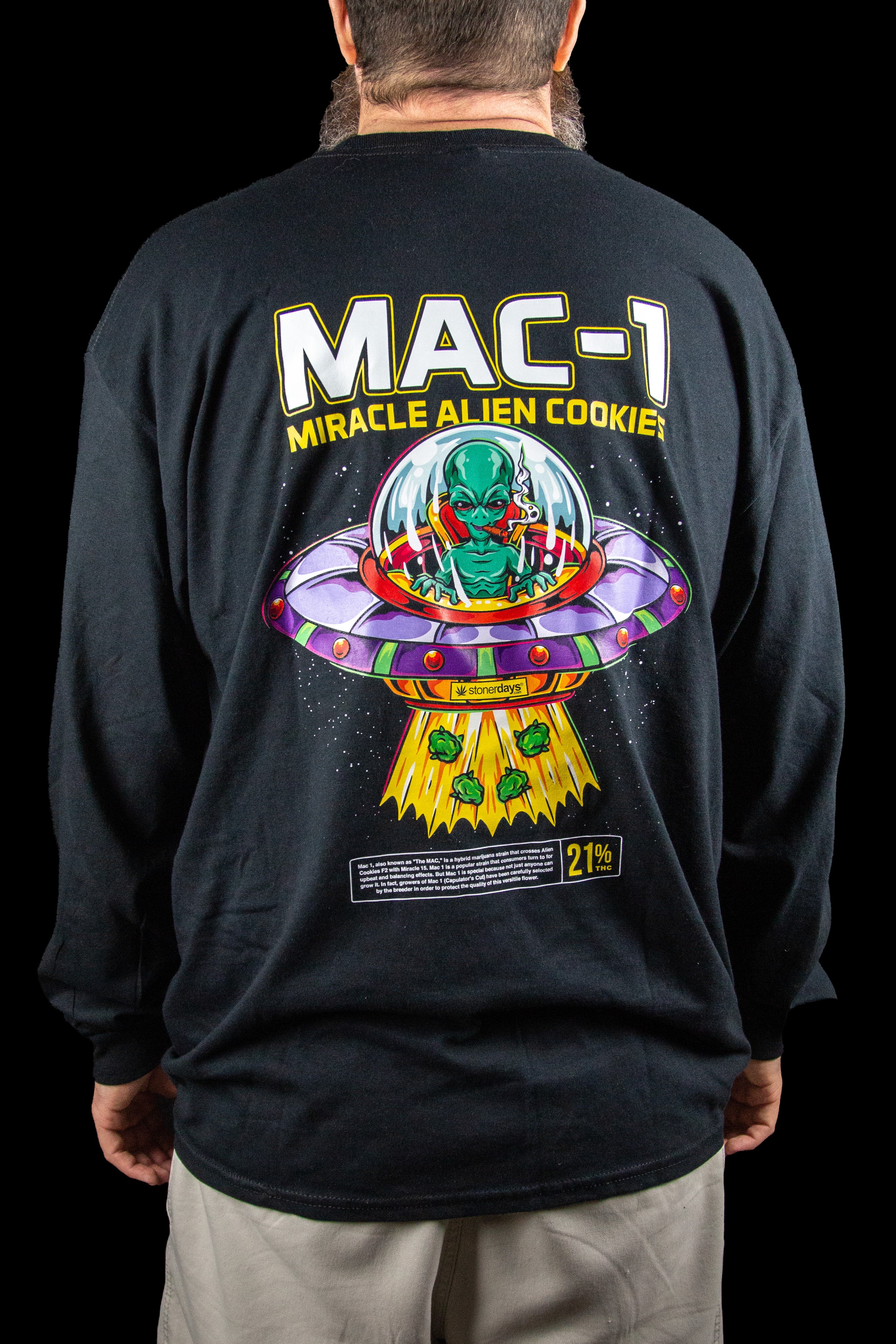 Long-sleeved black shirt with a colorful graphic of an alien piloting a UFO, labeled "MAC-1 Miracle Alien Cookies" with a THC percentage of 21%.