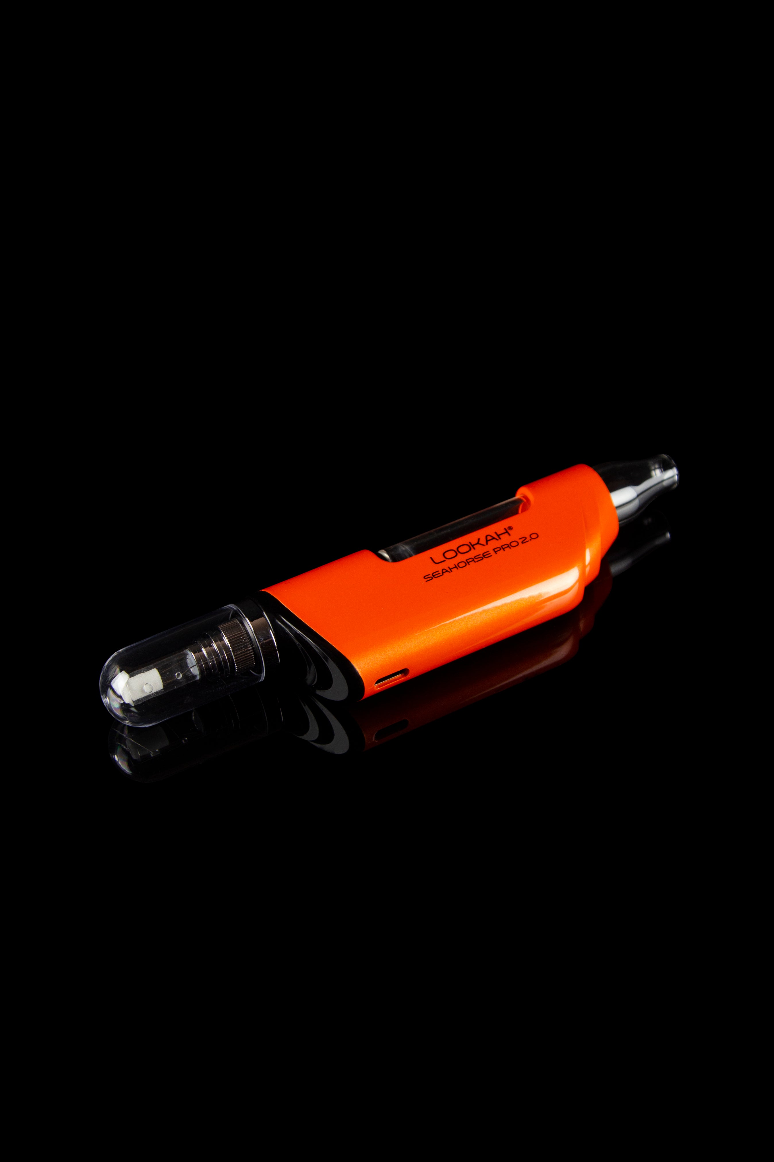 Orange Seahorse Pro 2.0 travel case for a cannabis vape pen, displayed on a reflective black surface.