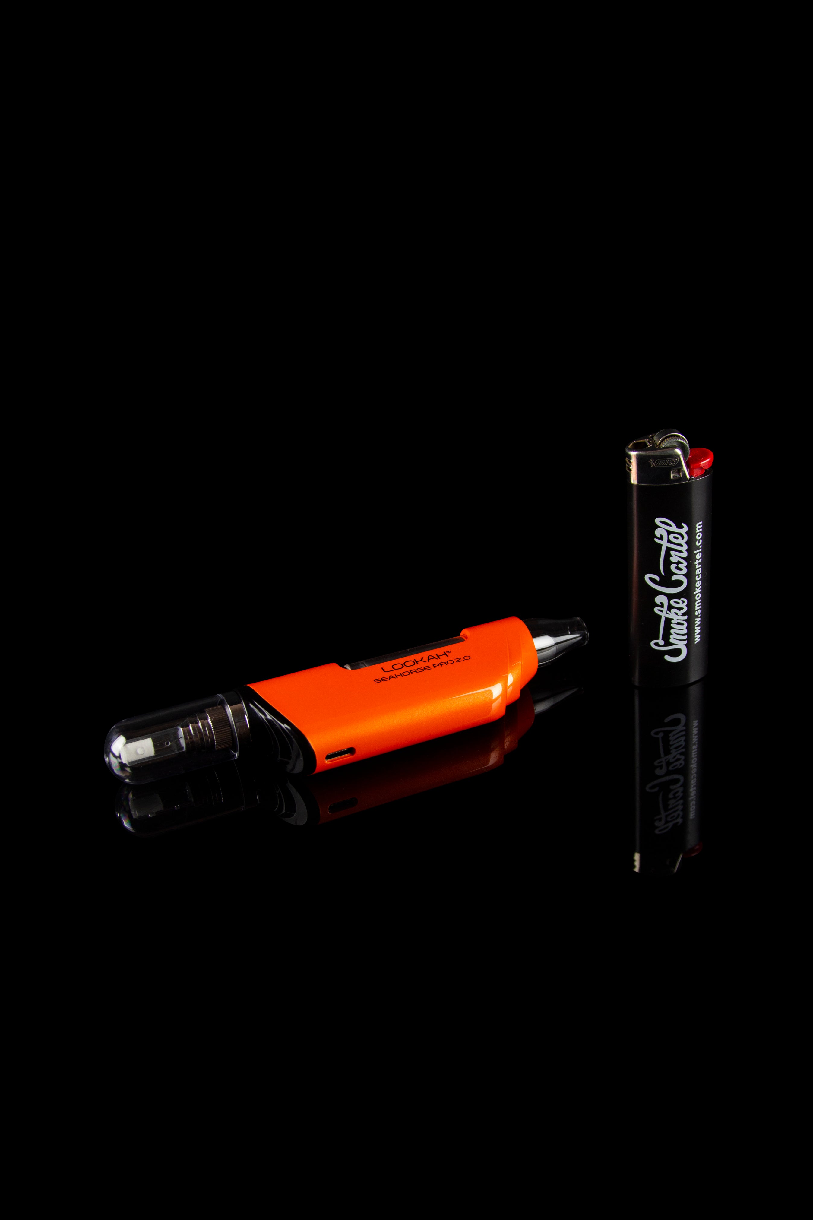 Orange and black cannabis vaping device with a lighter on a black background.