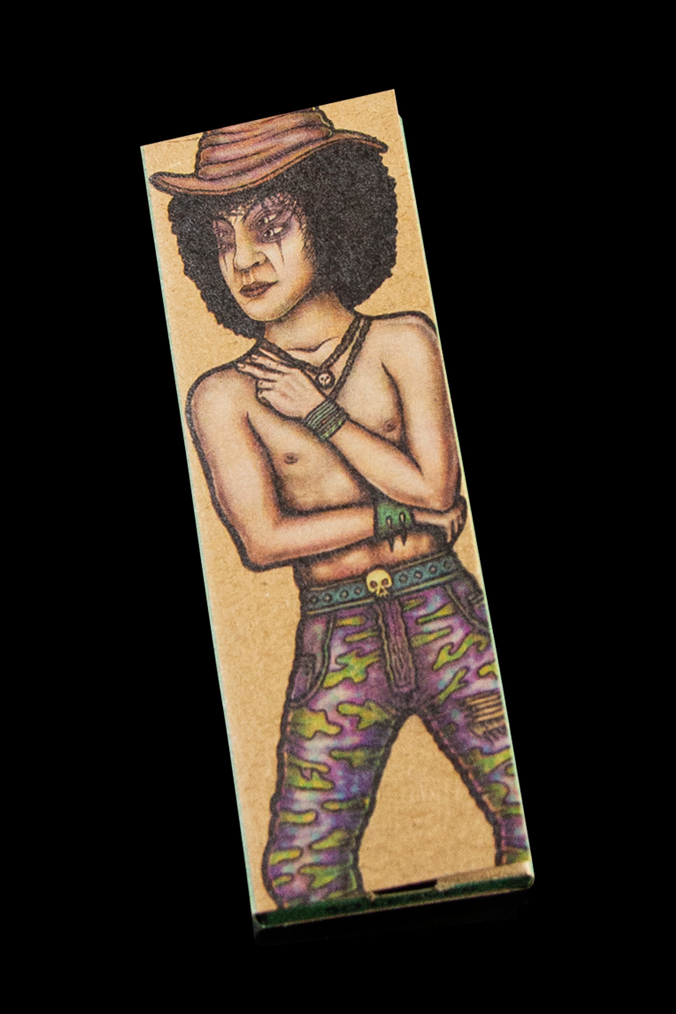 A slim, rectangular rolling paper booklet features a detailed illustration of a shirtless man with a hat and patterned pants, designed with gothic or alternative aesthetics.