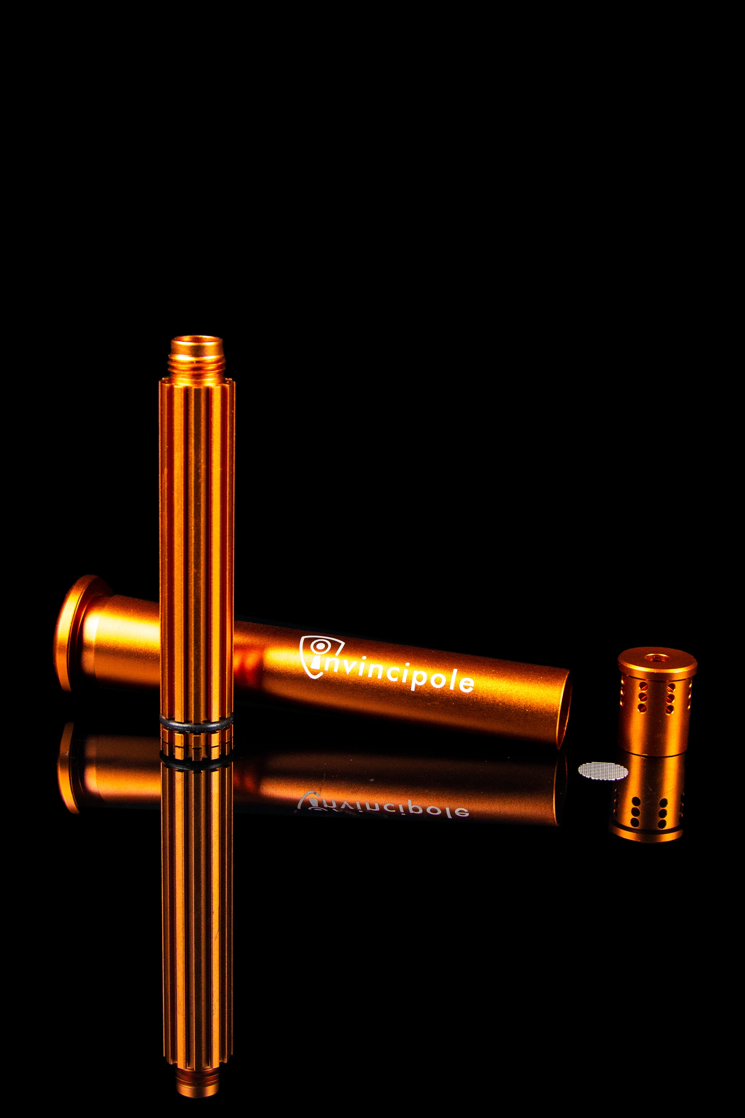 Orange cannabis oil applicator with reflective surface.