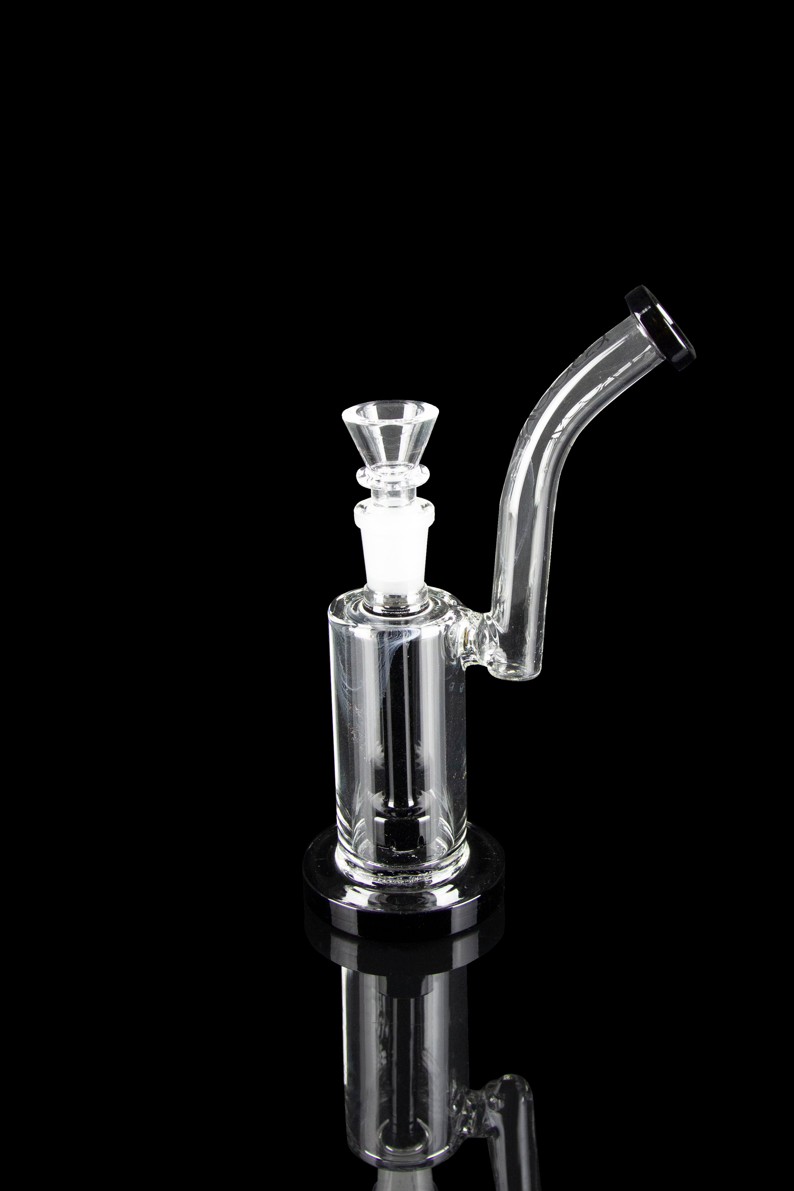 Clear glass bubbler with a flared mouthpiece and angled neck, reflecting on a dark surface.