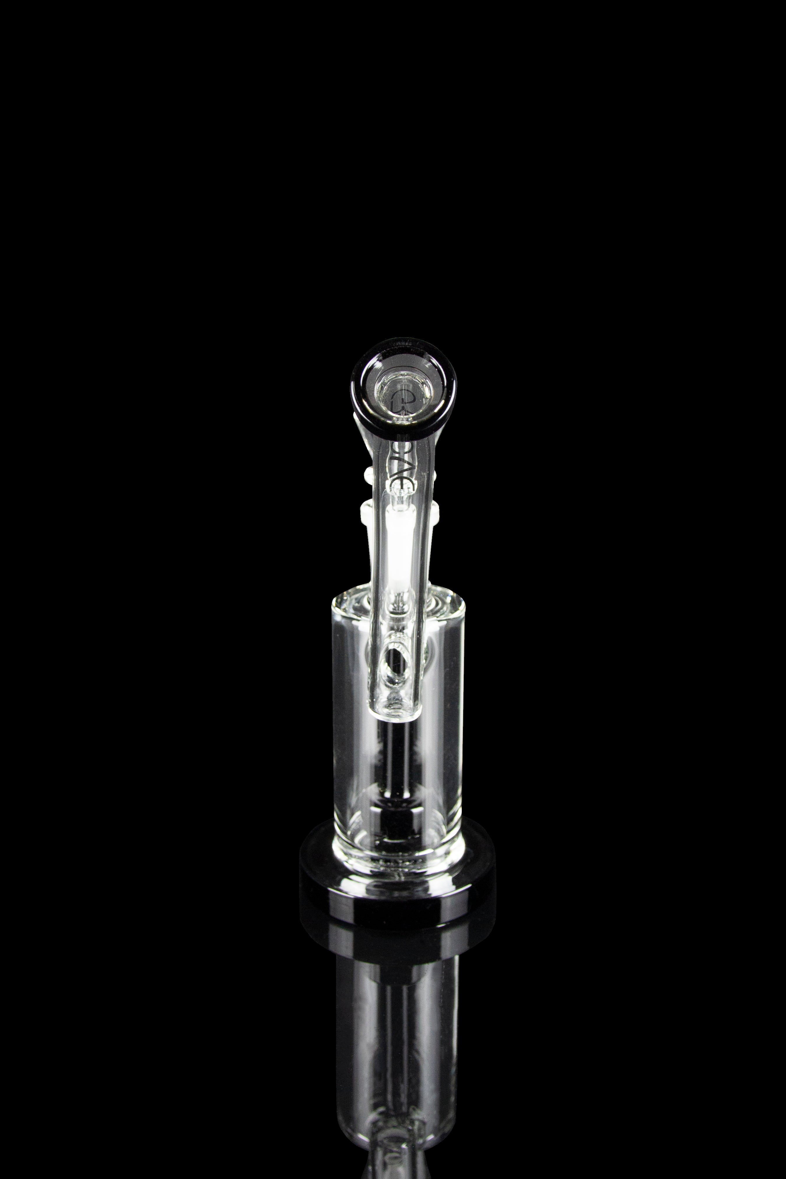 Clear glass water pipe (rig) with intricate design, reflecting on a black surface.