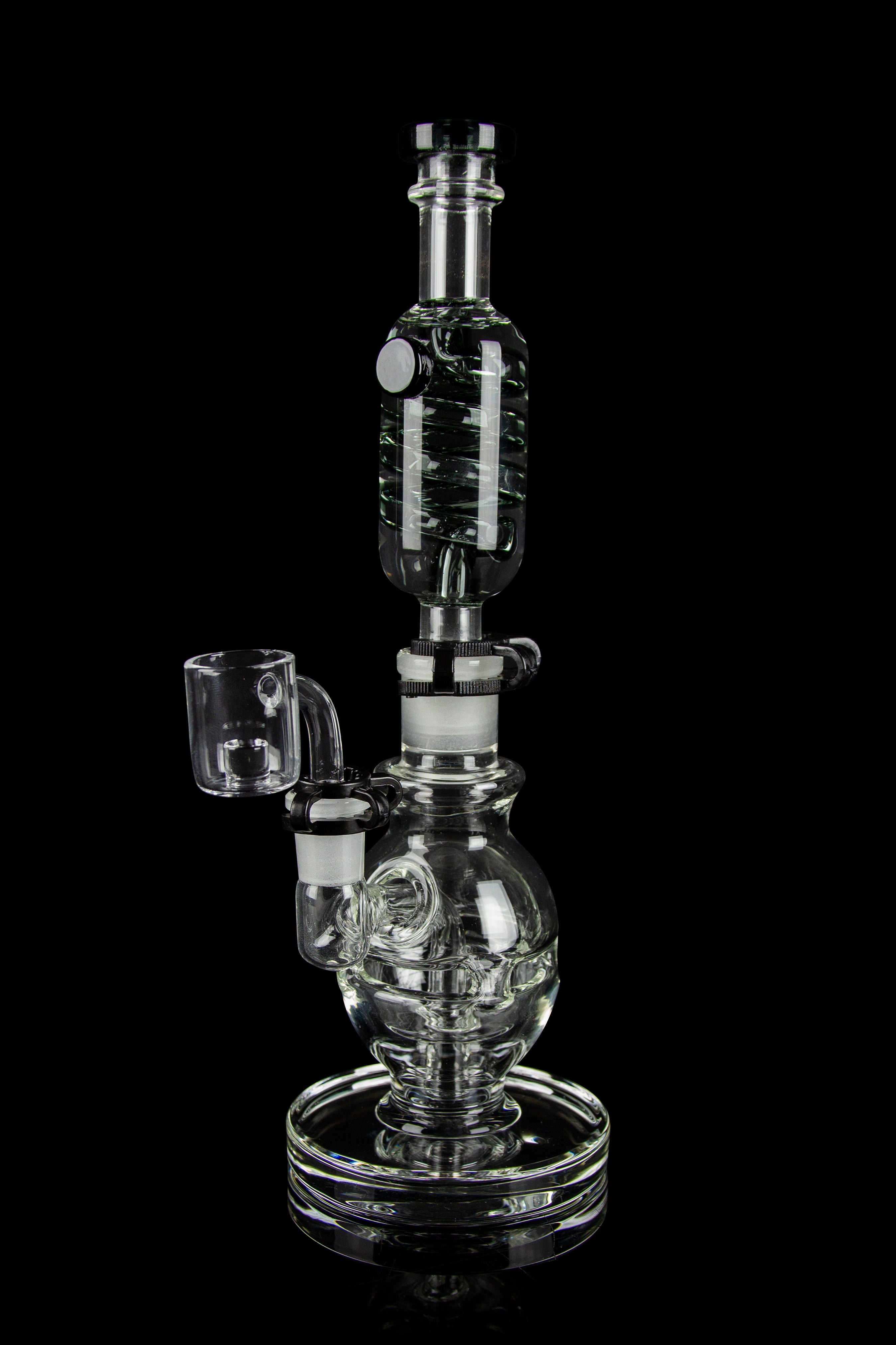 Clear glass water pipe (rig) with a quartz banger, isolated on a black background.