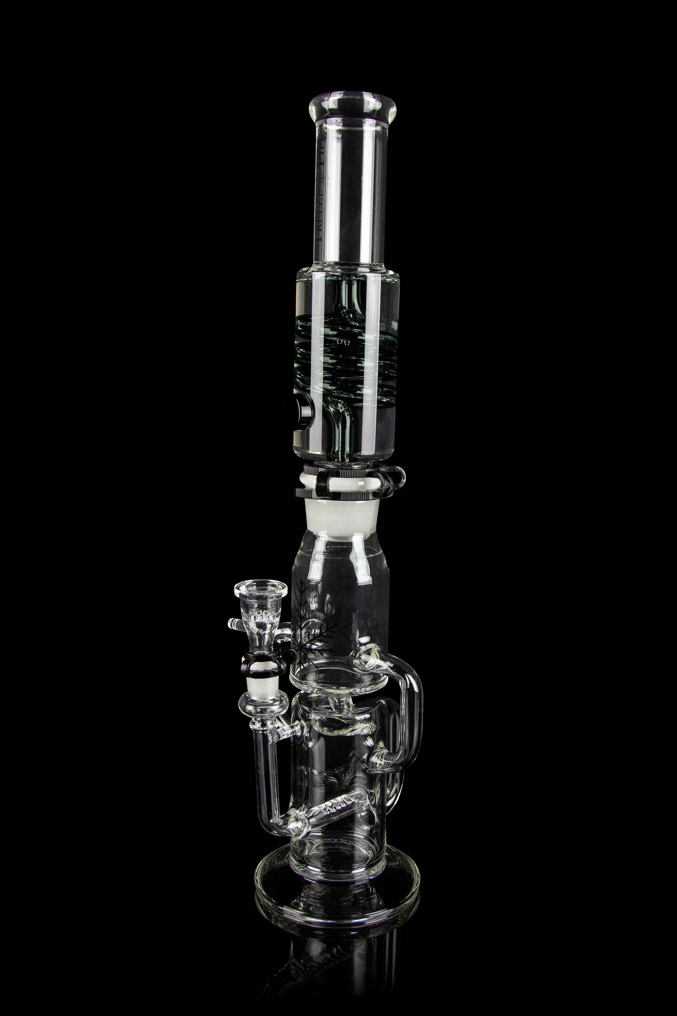 Clear glass water pipe (bong) with multiple chambers and a glass bowl, isolated on a black background.
