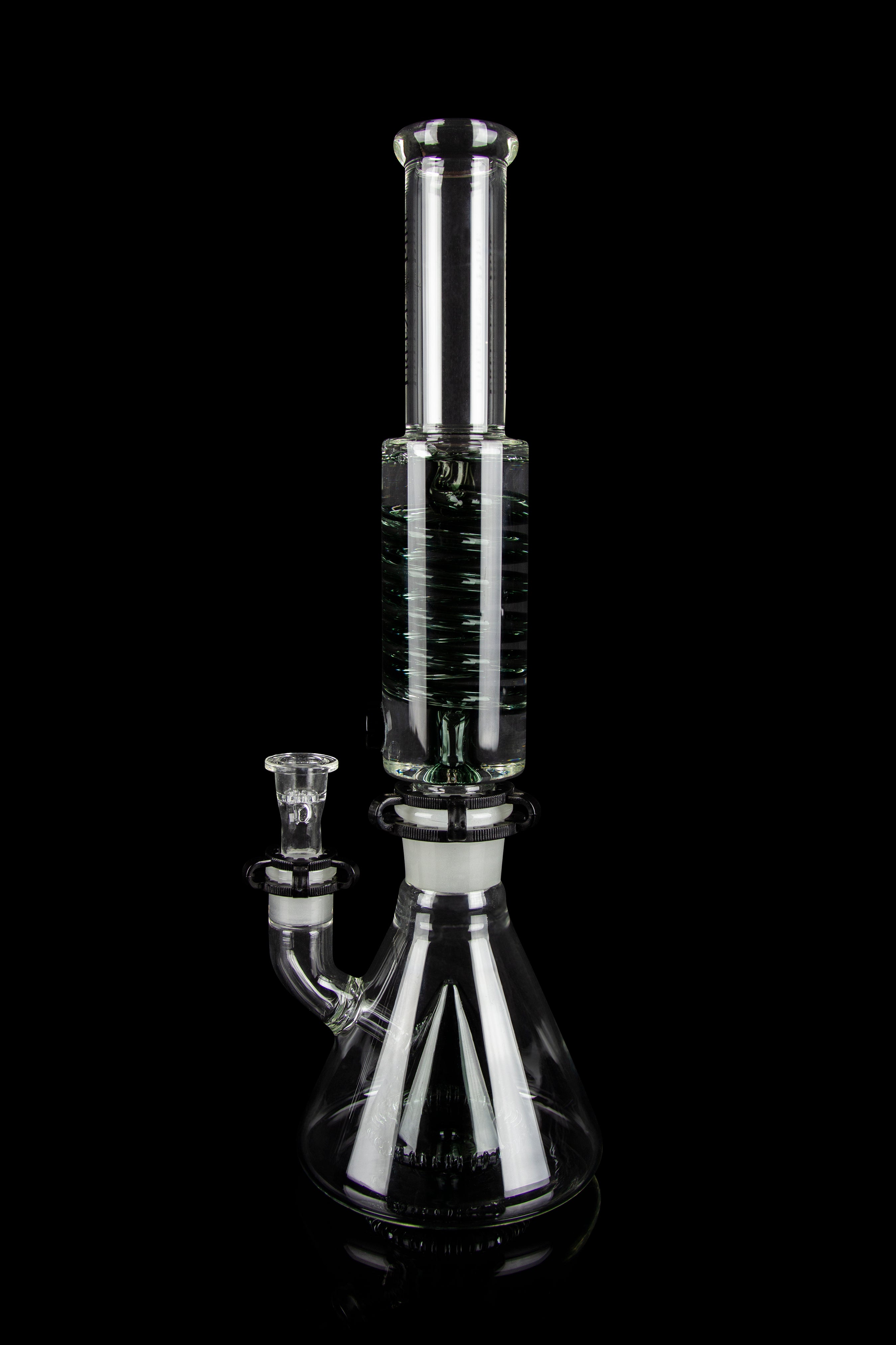 Clear glass water pipe (bong) with intricate branching percolator, isolated on black.