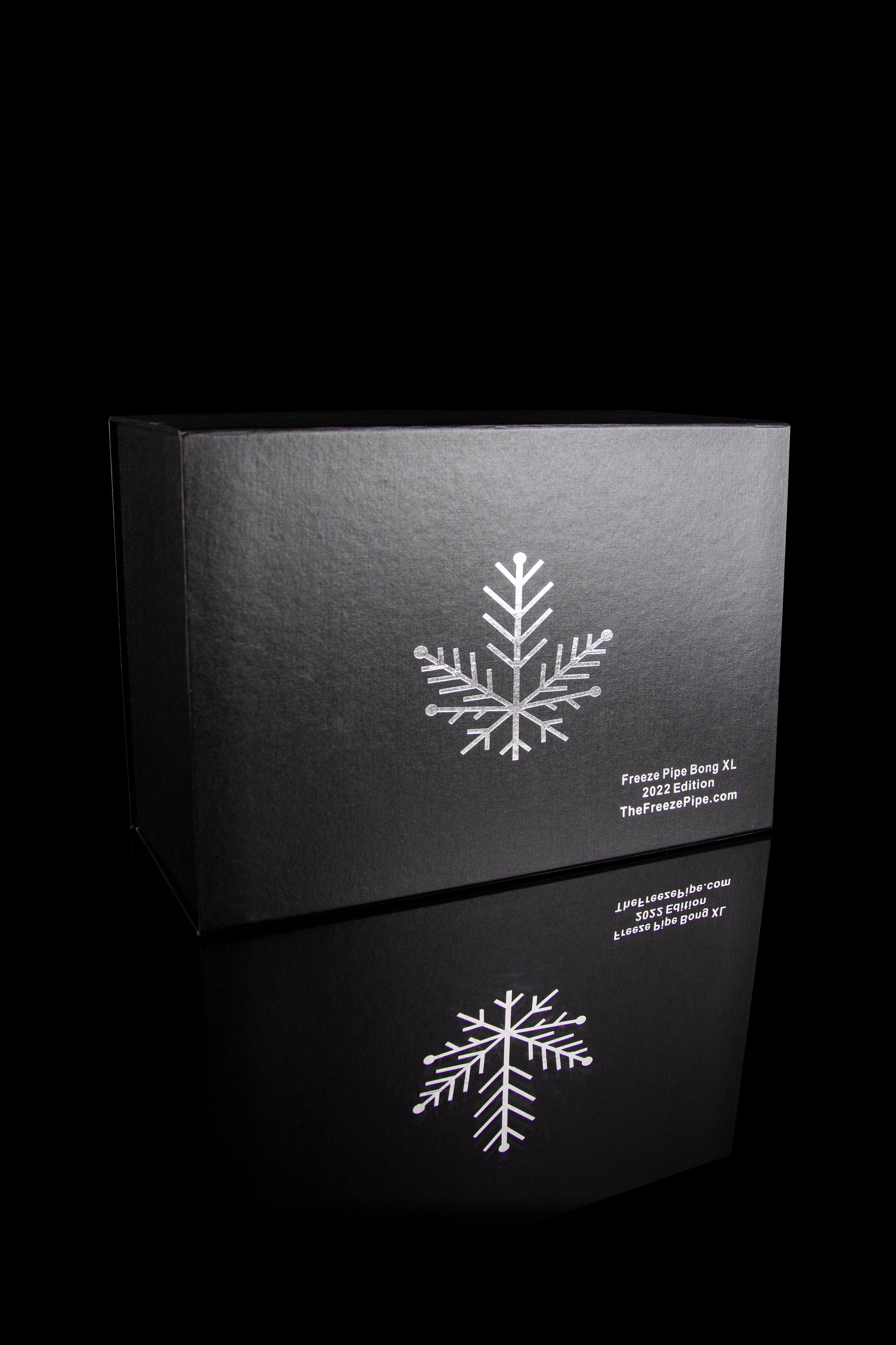 Black box with white snowflake design and text indicating “Freeze Pipe Bong XL 2022 Edition” and website address.