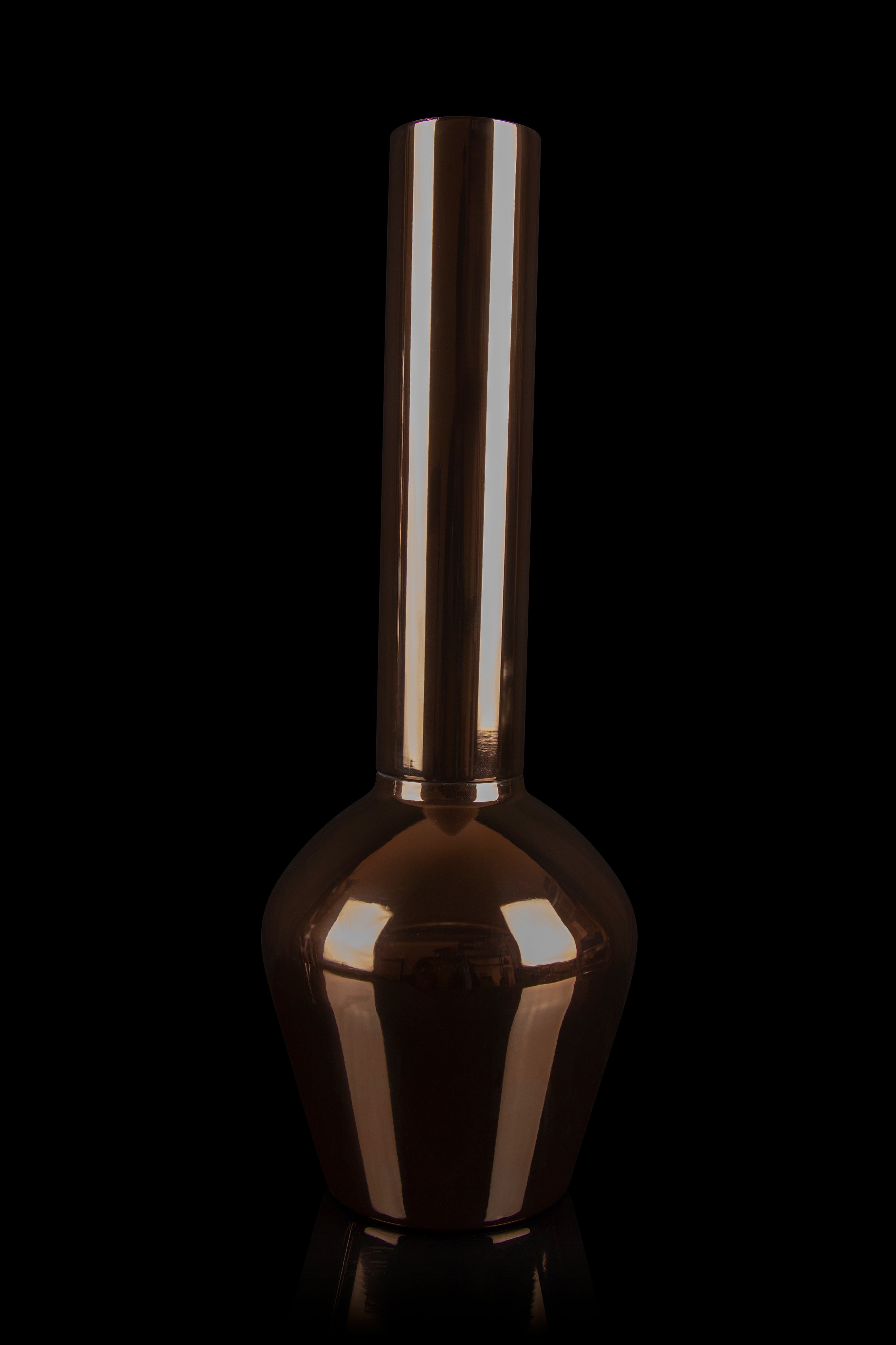 Copper-colored glass bong against a black background.