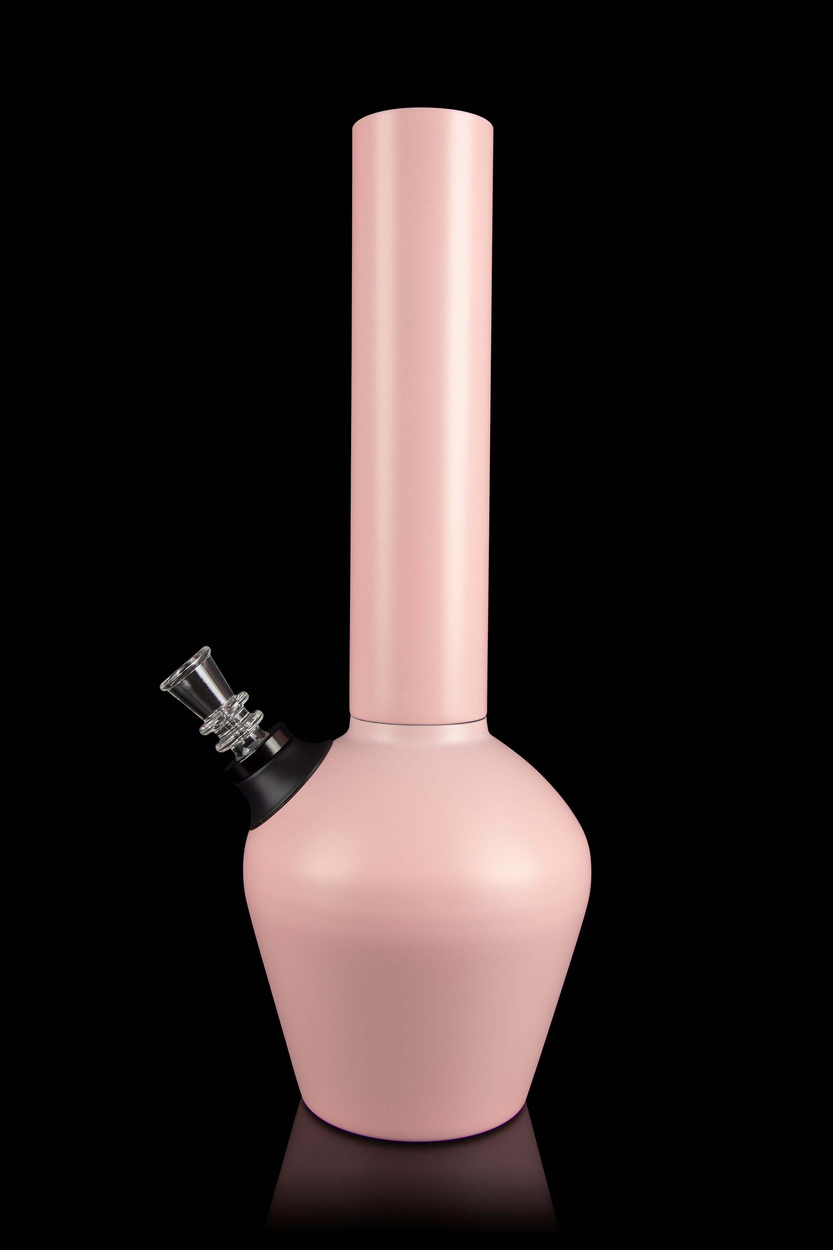 Pale pink glass water pipe (bong) with a glass bowl piece, studio shot on a black reflective surface.