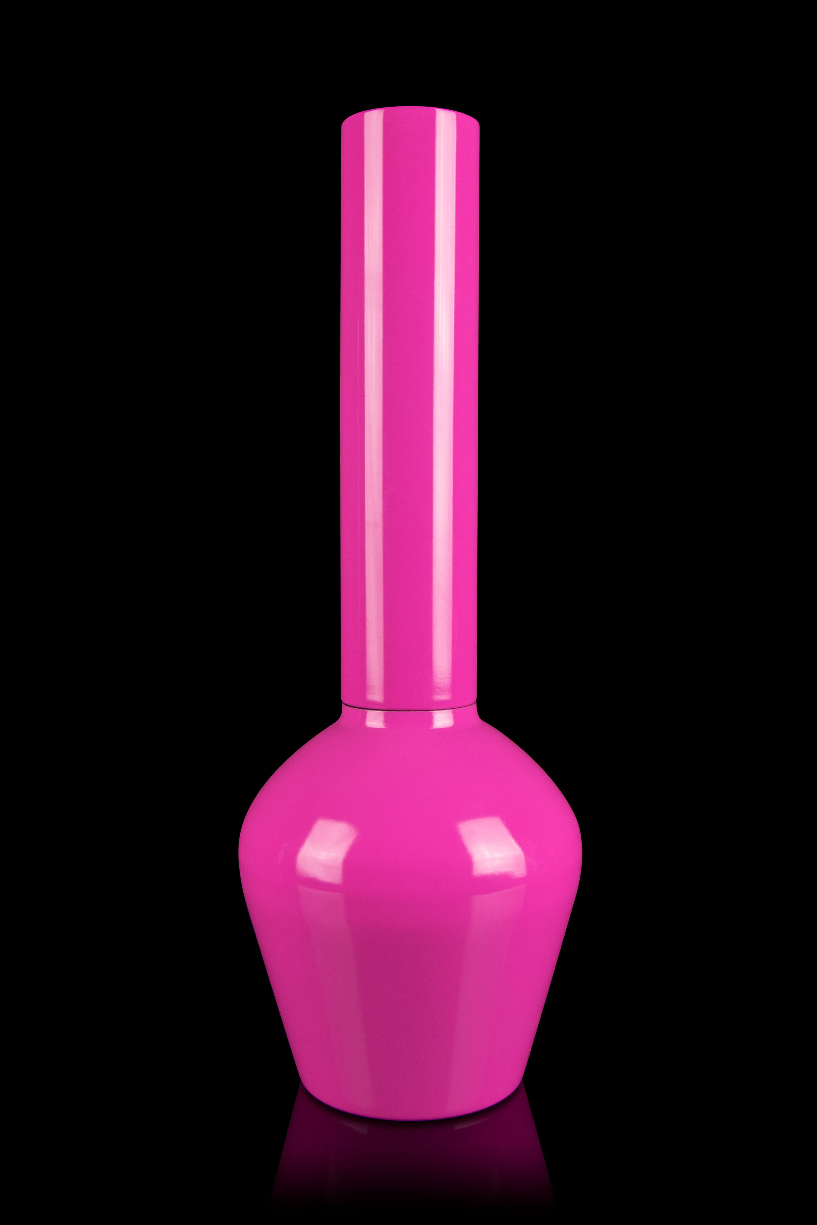 Pink glass cannabis water pipe isolated on a black background.