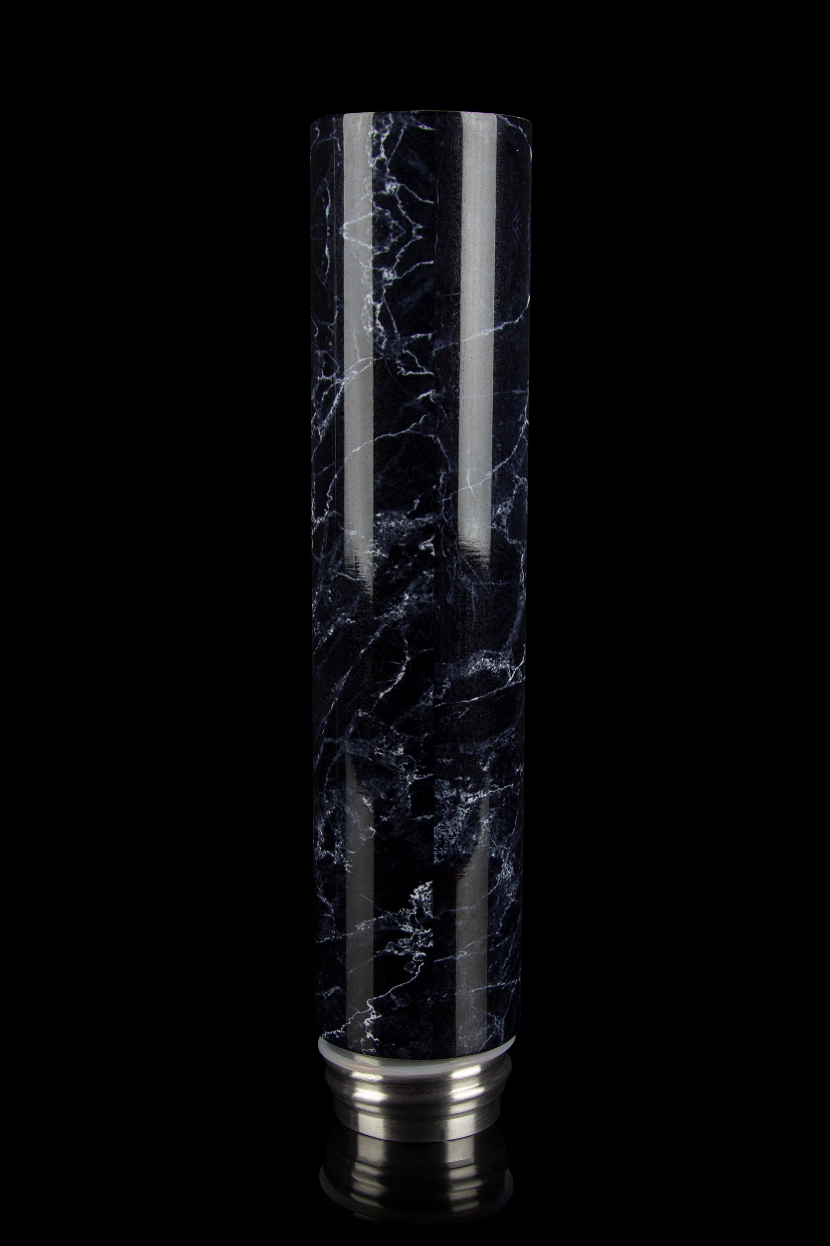 Black and white marbled glass cannabis water pipe (bubbler) with silver accents, isolated on a black background.