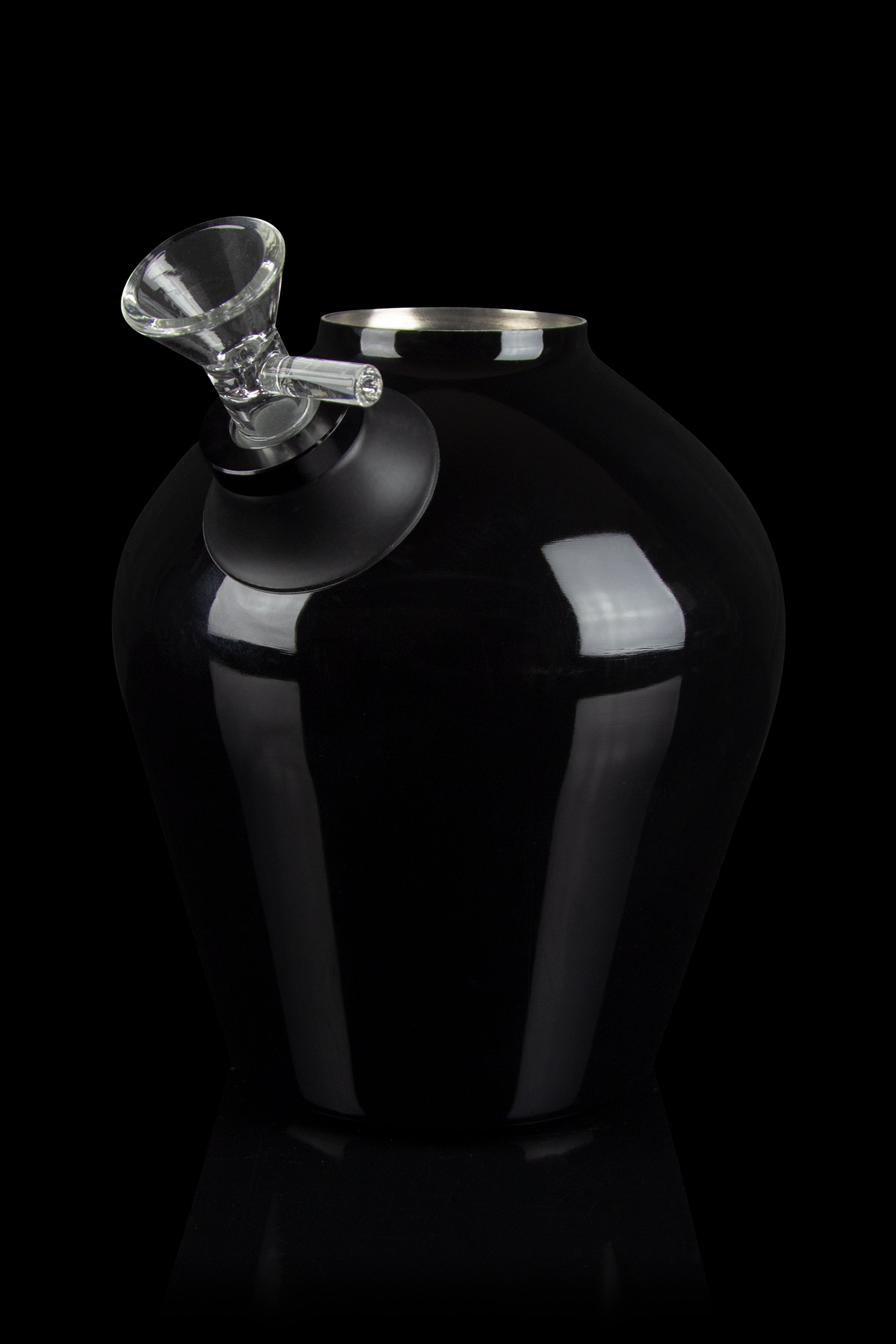 Black cannabis vaporizer with a glass mouthpiece, studio shot.