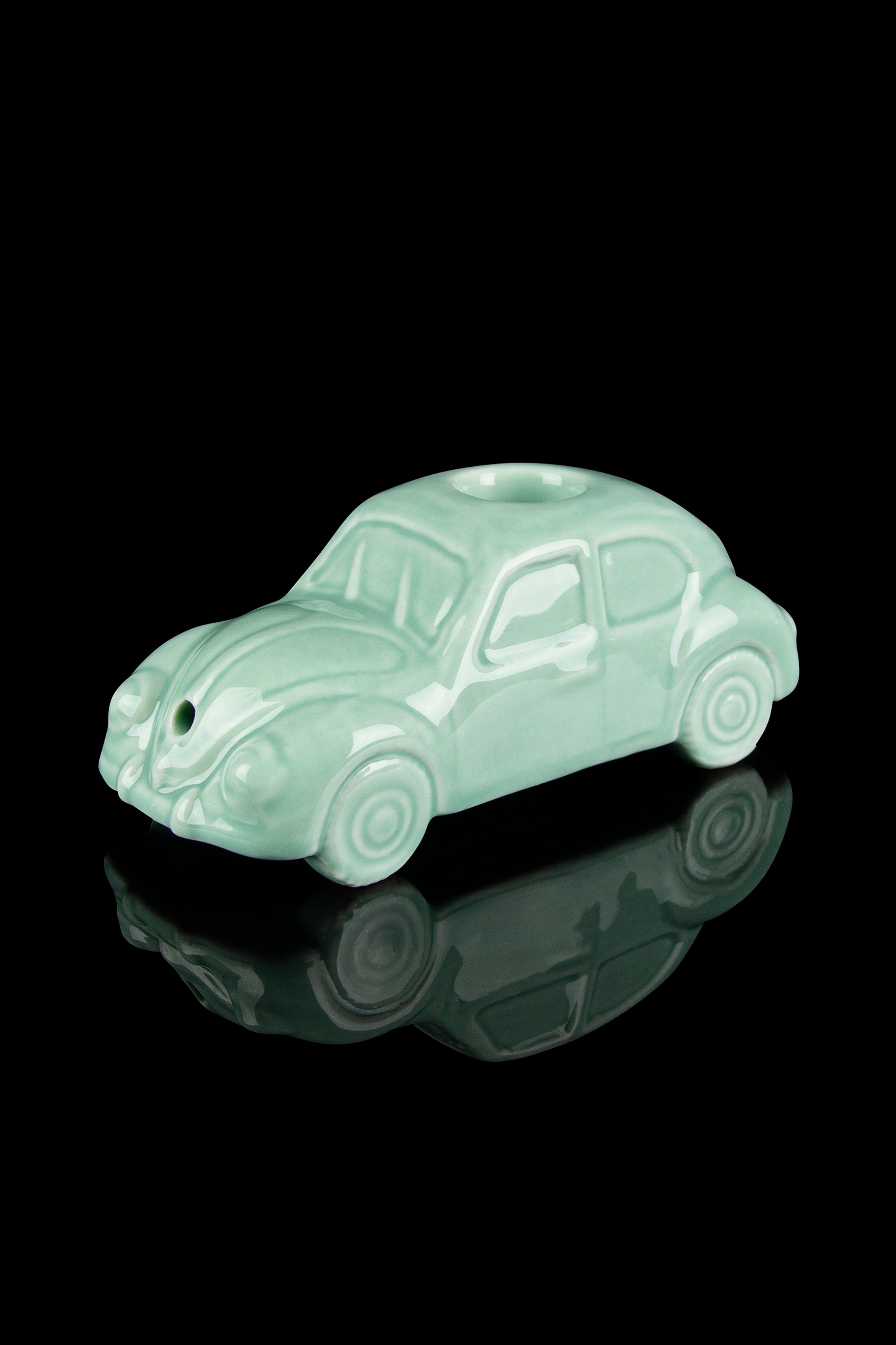 Mint green Volkswagen Beetle-shaped glass pipe with a glossy reflective surface.