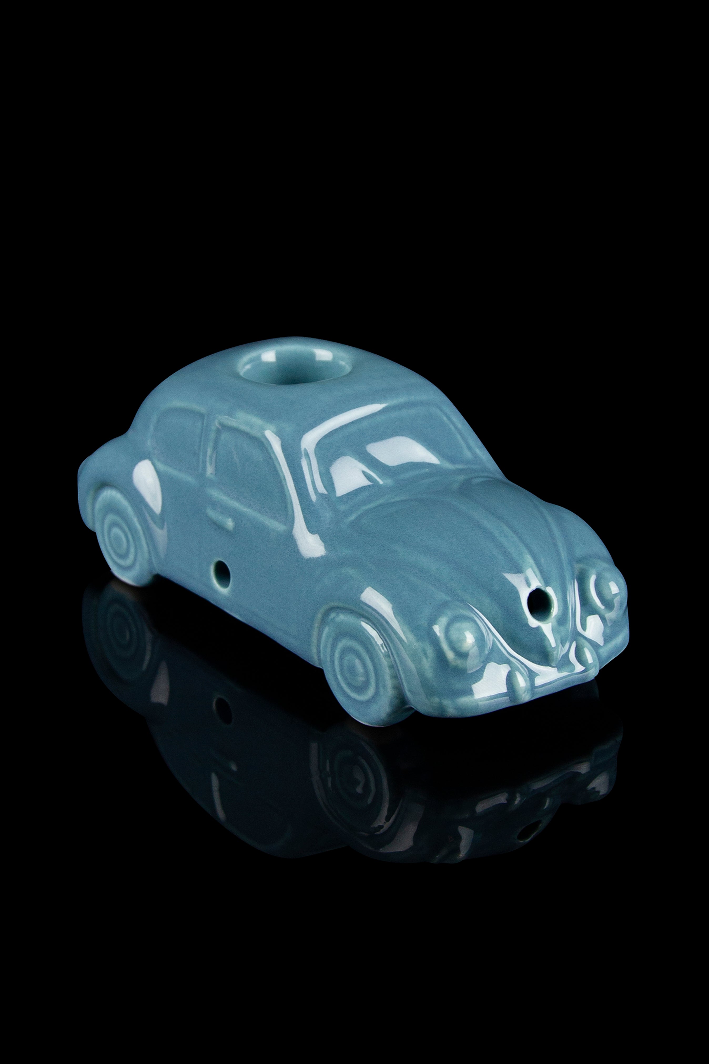 Ceramic pipe shaped like a vintage teal Volkswagen Beetle car.