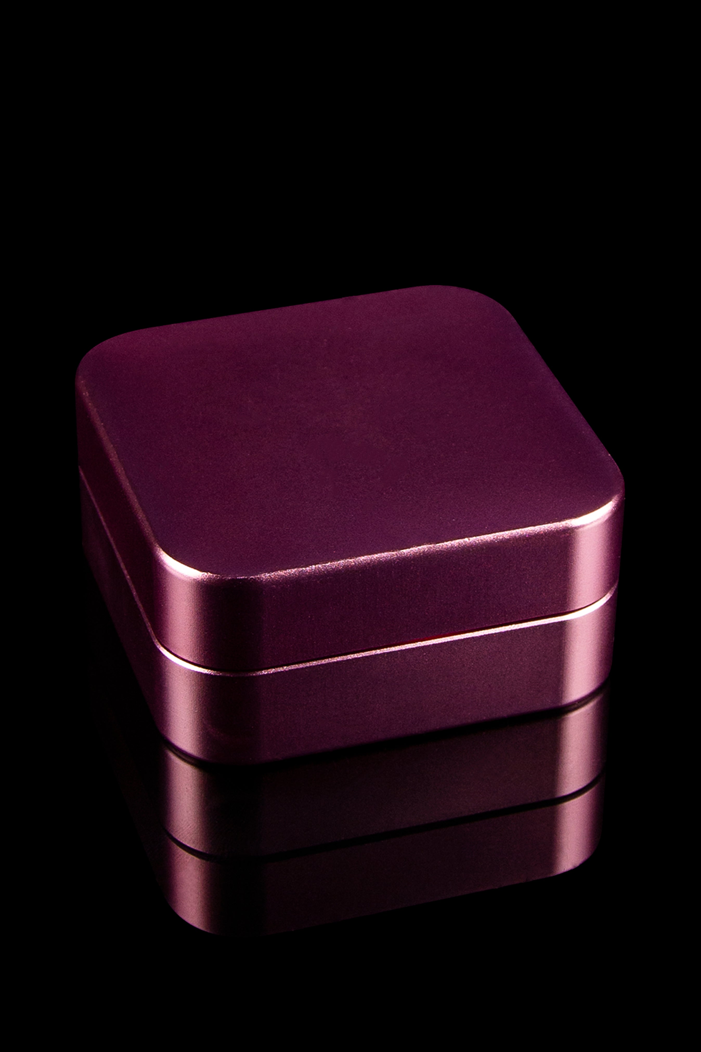 Burgundy metal storage box, likely for cannabis or accessories, against a black background.