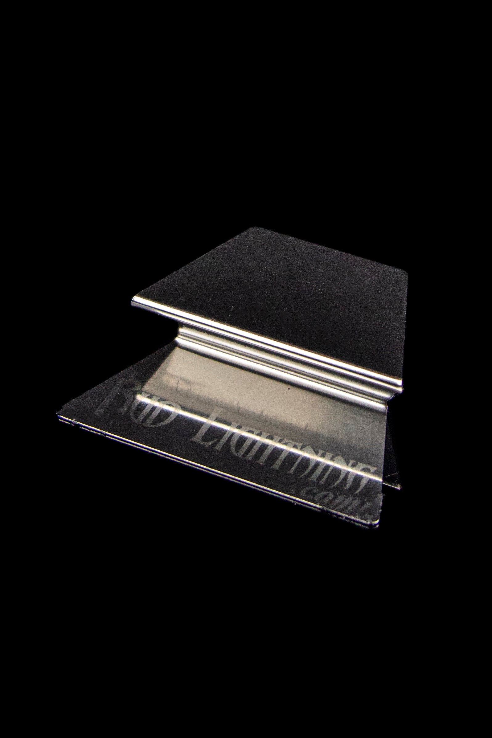 Sleek, silver cannabis smoking kit on a black background.