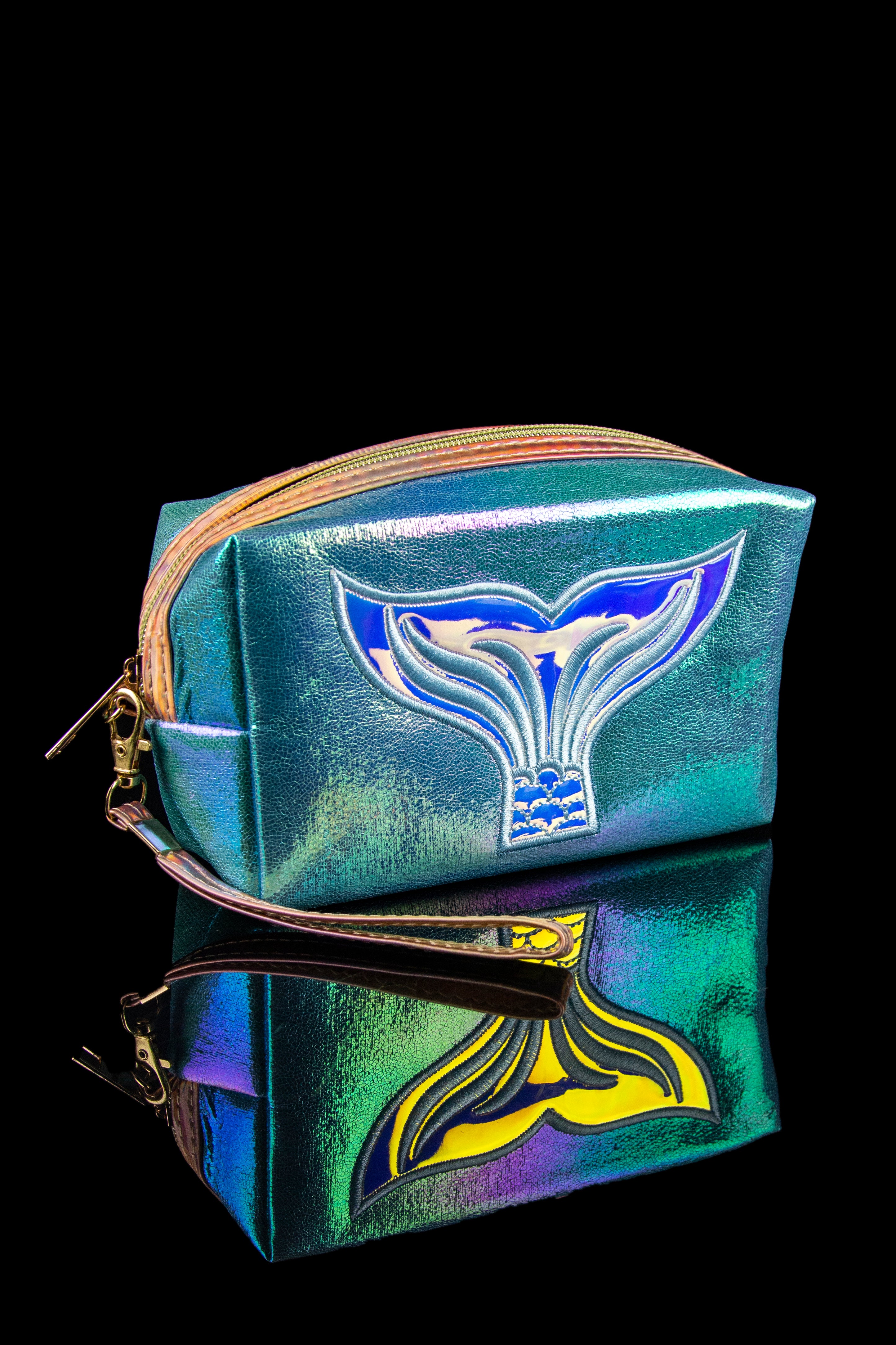 Iridescent cannabis accessory bag featuring a whale tail design, stacked on a reflective surface.