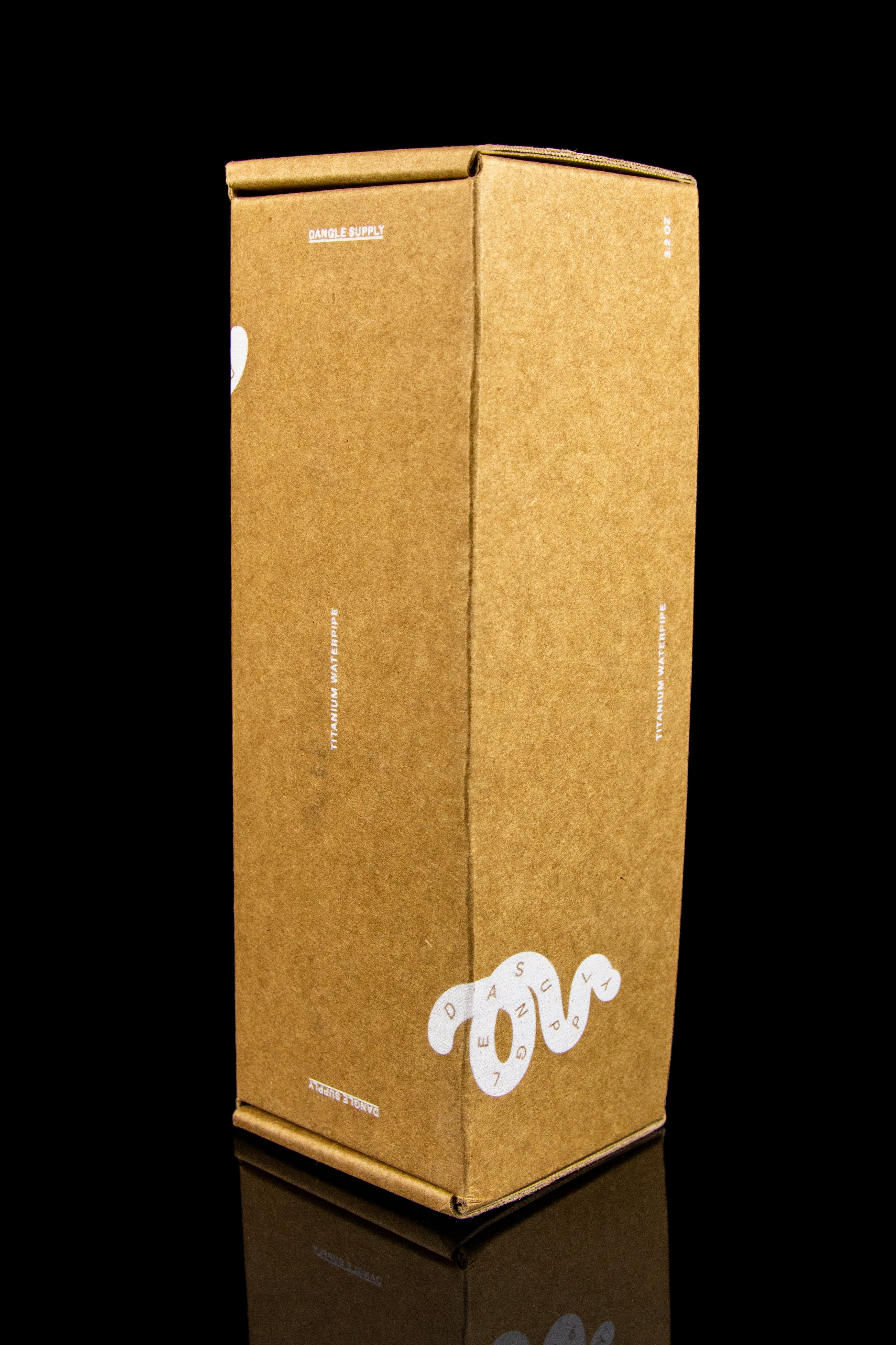 Brown cardboard shipping box for cannabis accessories with "Dangle Supply" logo and "Titanium Waterpipe" text.