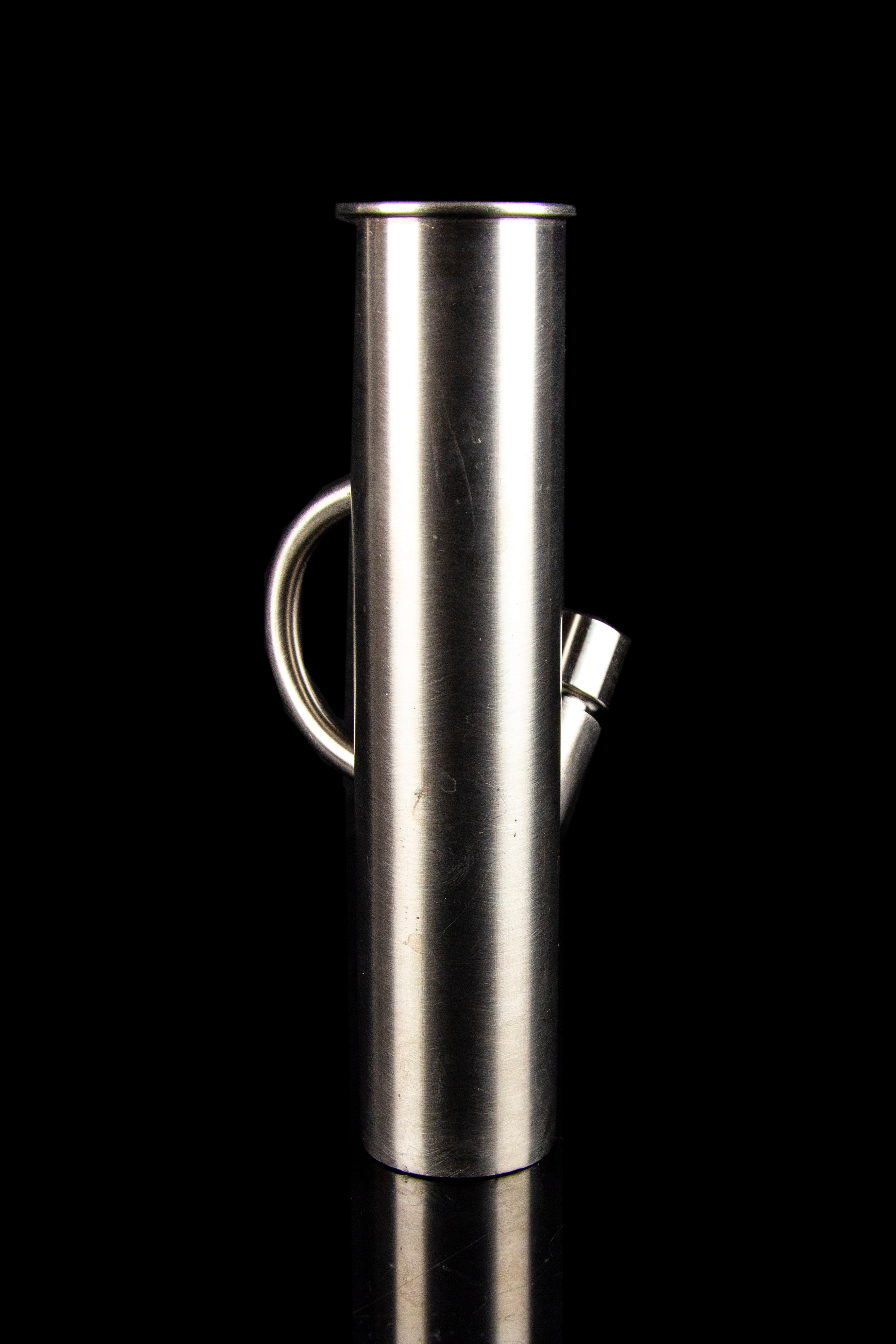 Stainless steel oil burner pipe with a looped handle, isolated on black.