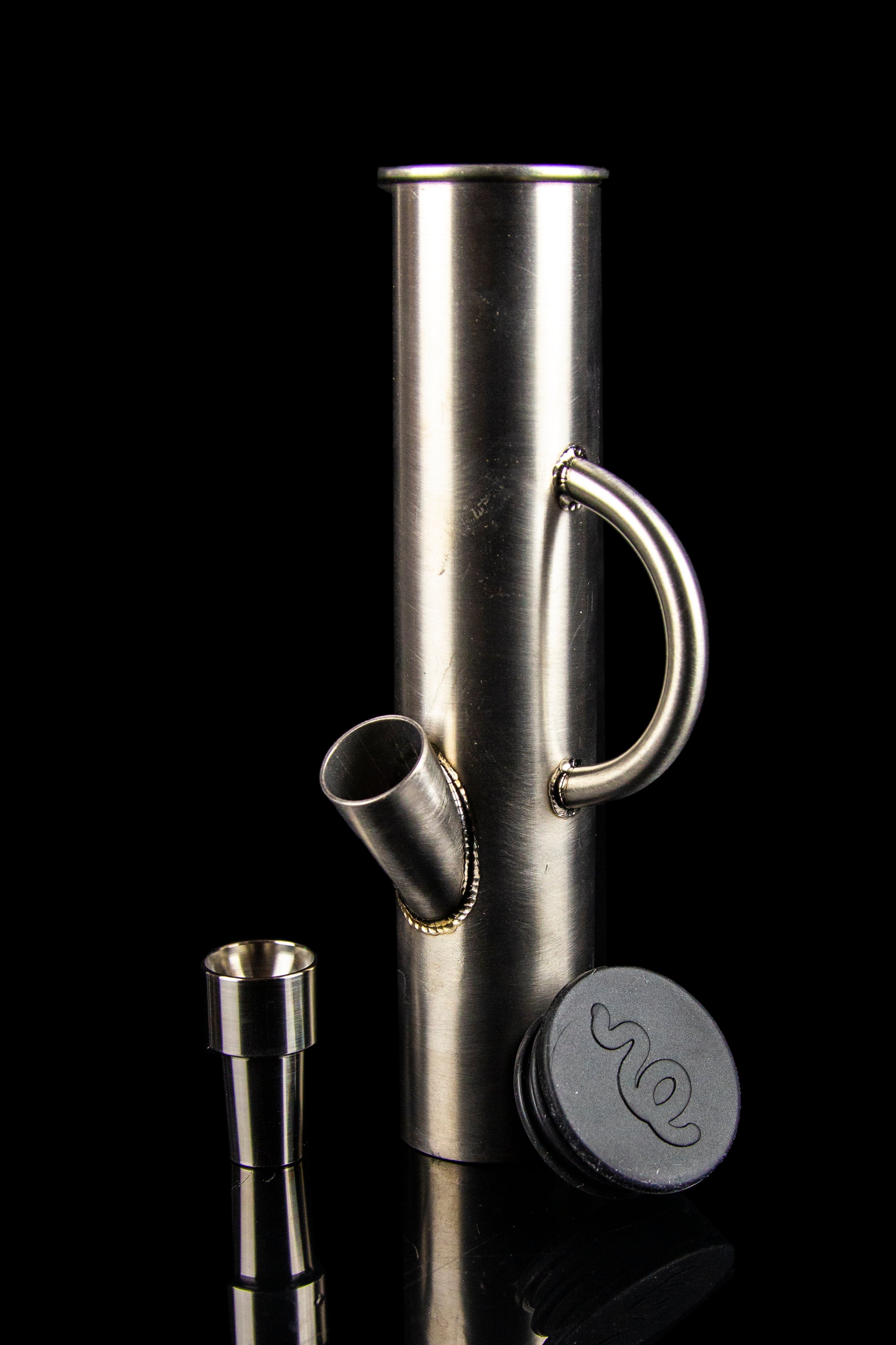 Stainless steel water pipe with detachable downstem and cap, isolated on black.