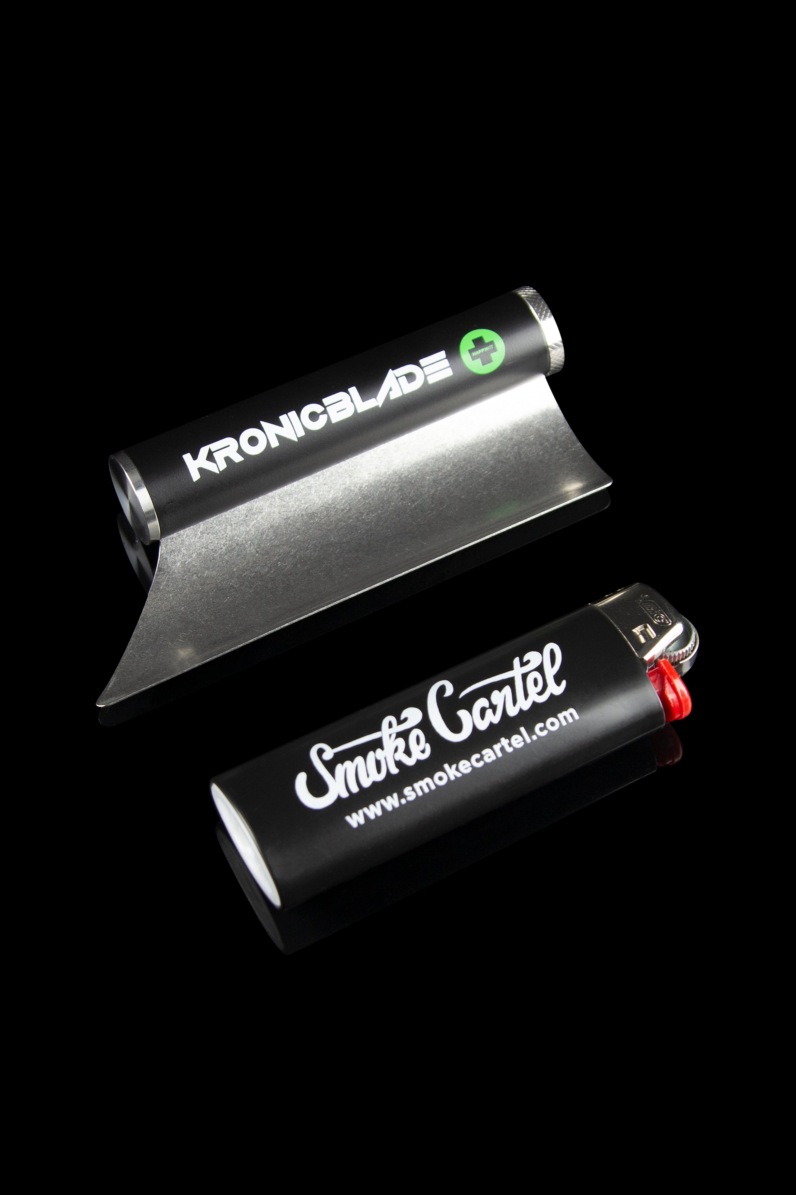Black cannabis grinder and lighter with branded logos on a dark background.
