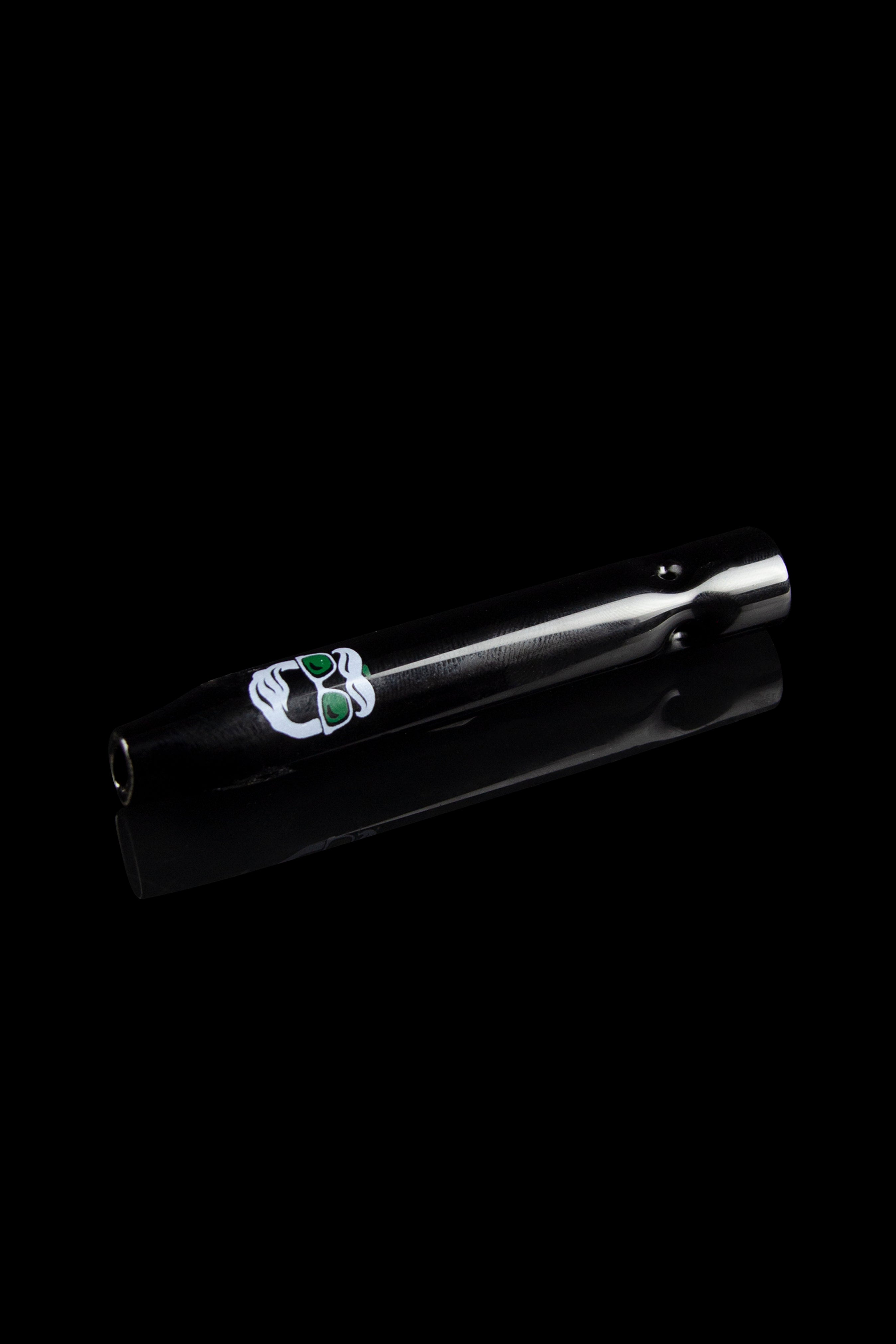 Black glass pipe with green cannabis leaf design, isolated on a dark background.
