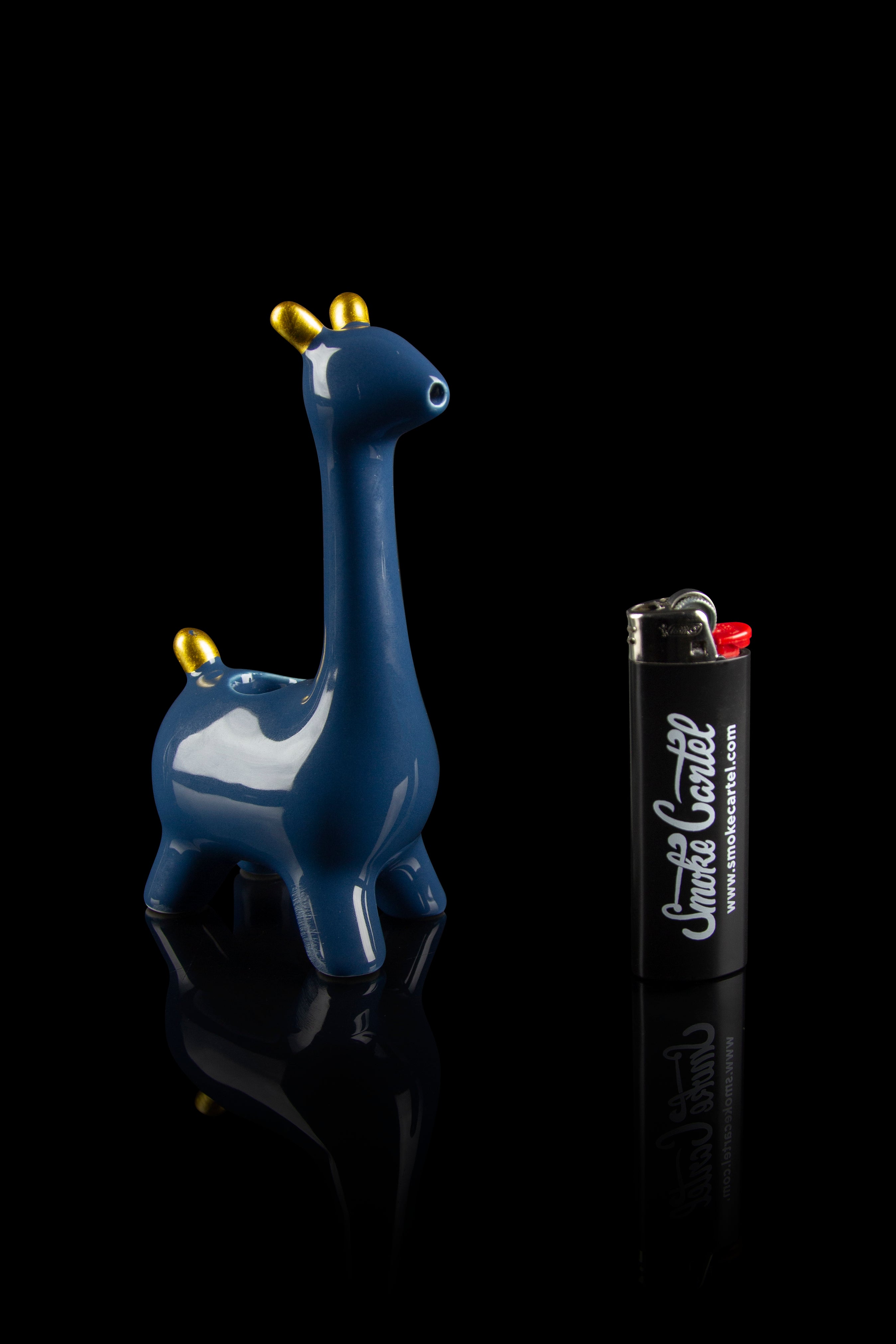 Blue ceramic giraffe water pipe with a branded lighter beside it, studio shot on a reflective black surface.