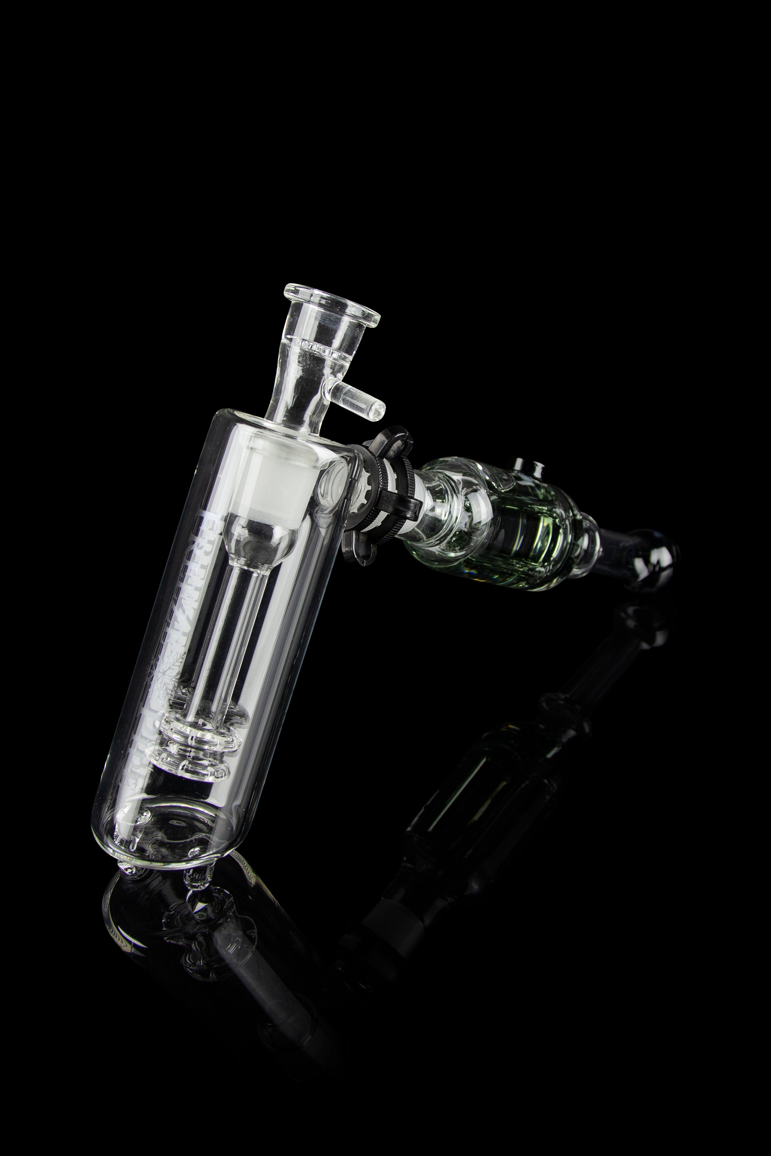 Clear glass bubbler and oil rig with intricate design, isolated on black.