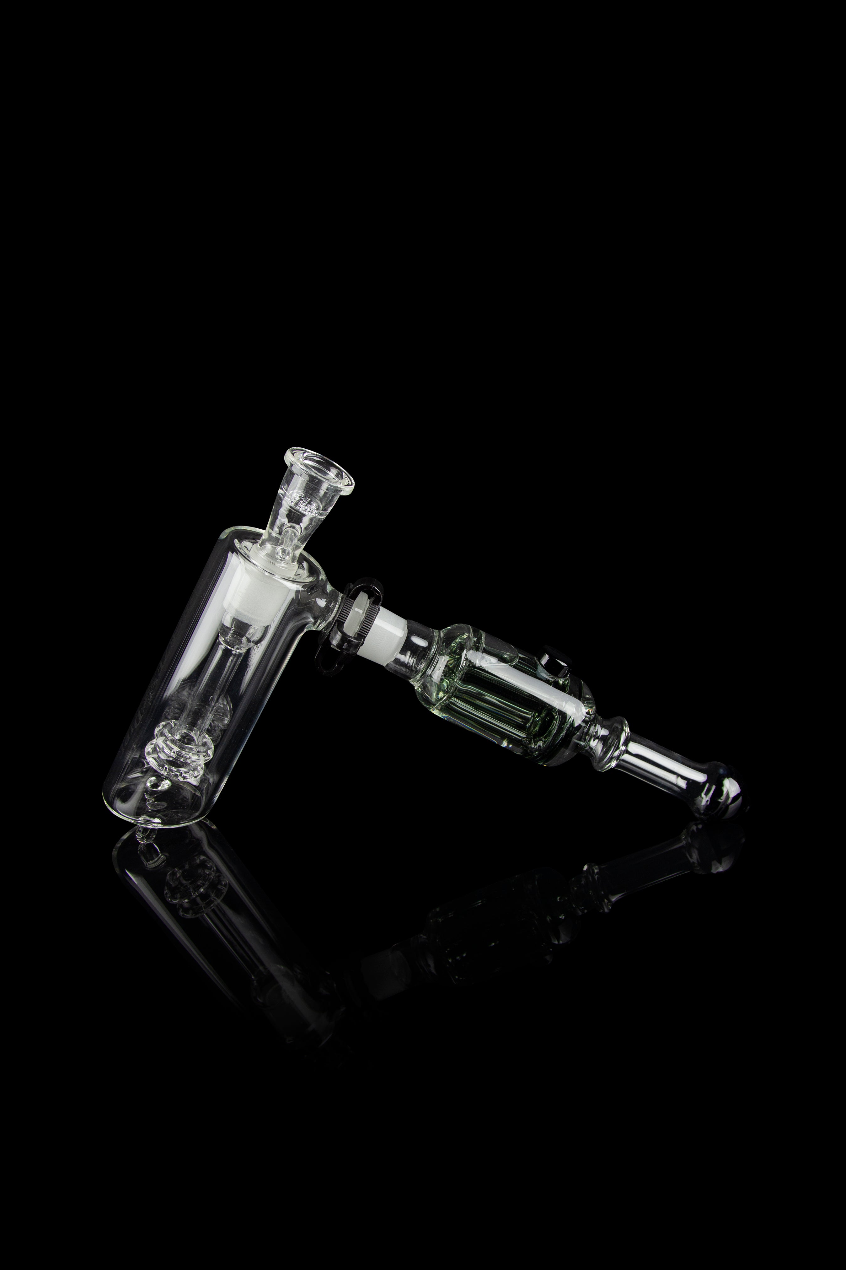 Glass rig with bubbler and connection for dabbing, isolated on black.