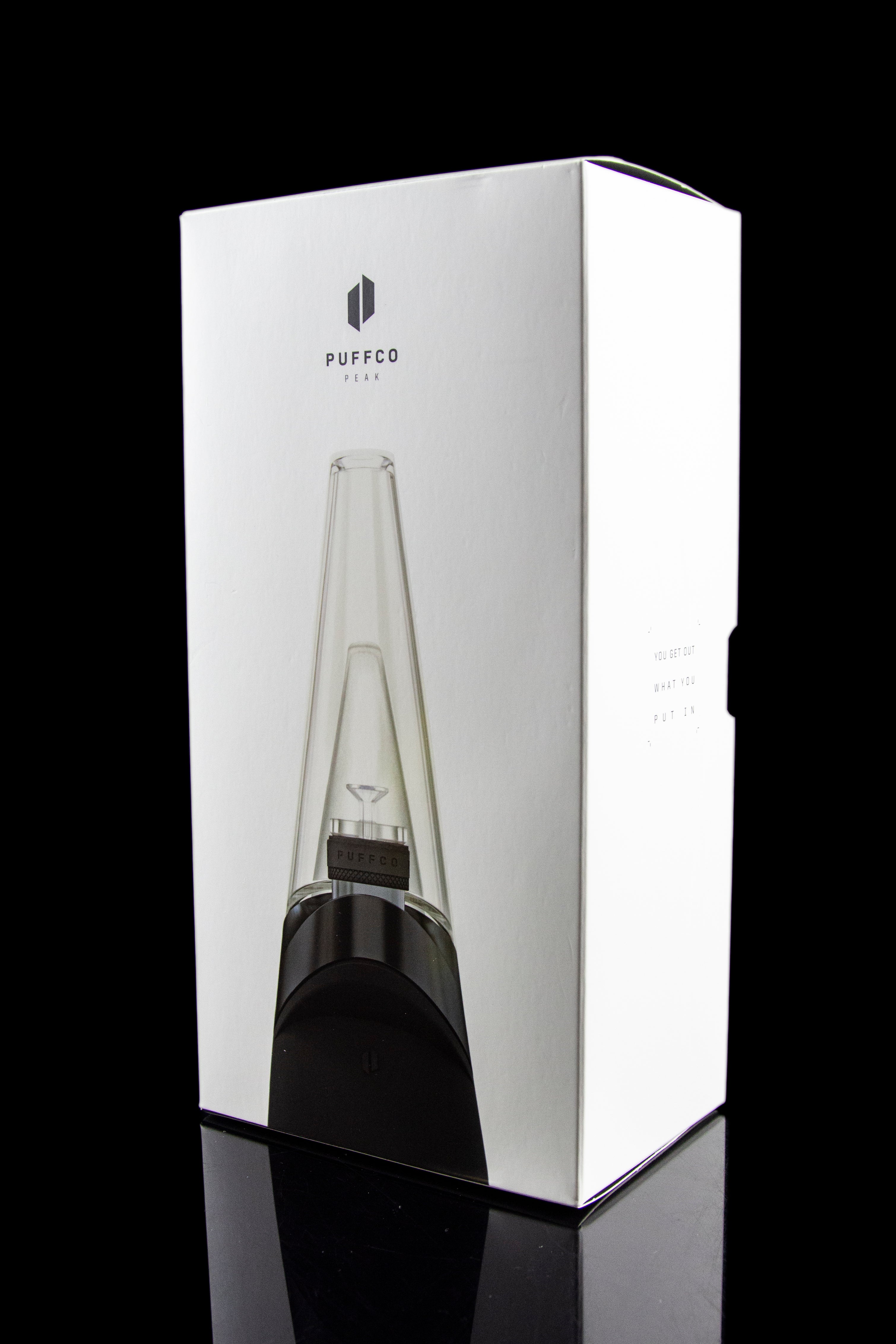 Puffco Peak portable dab rig with glass water pipe, displayed in its white packaging.