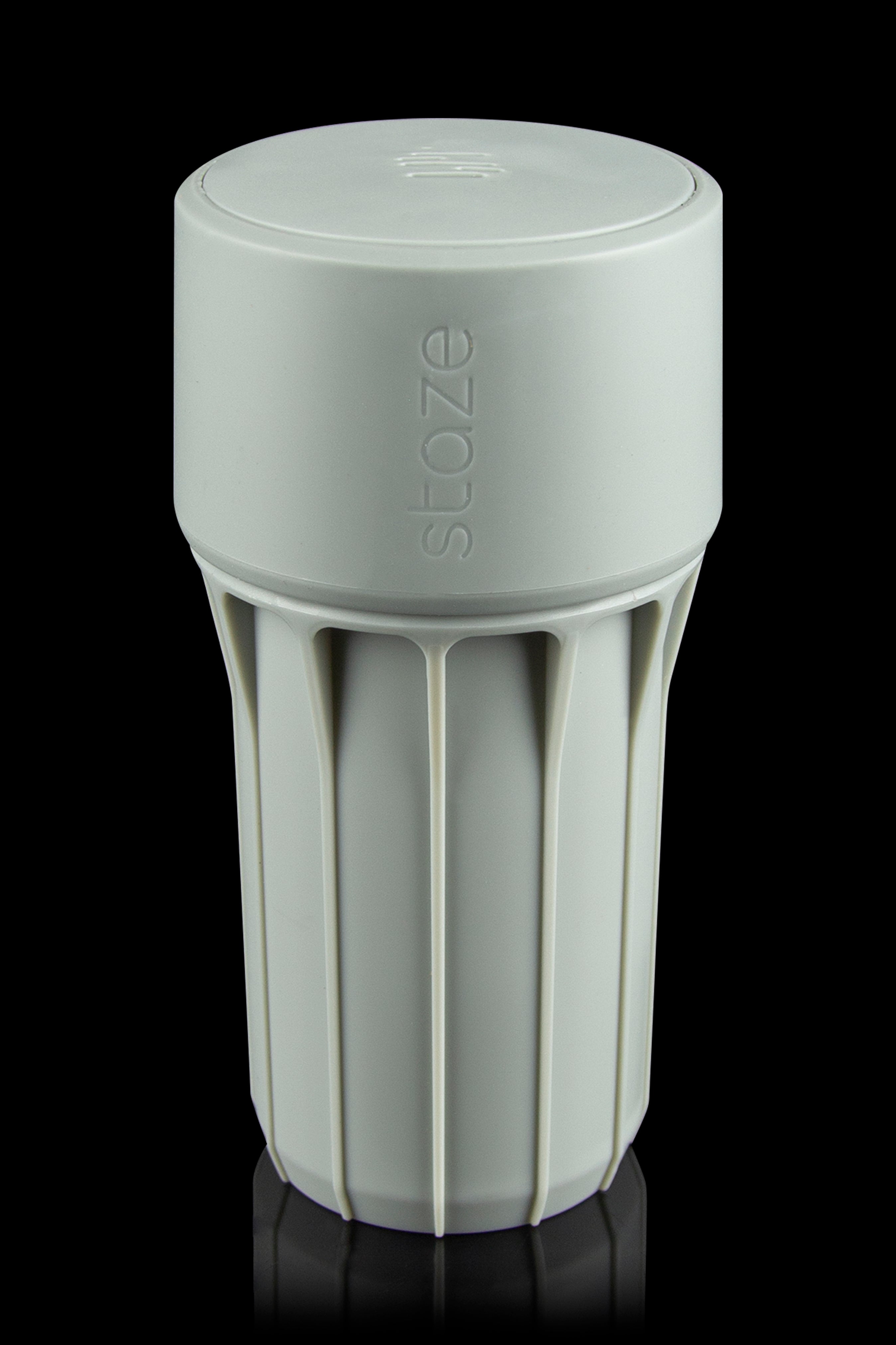 Light green Stoze cannabis container with a ribbed design and airtight seal.