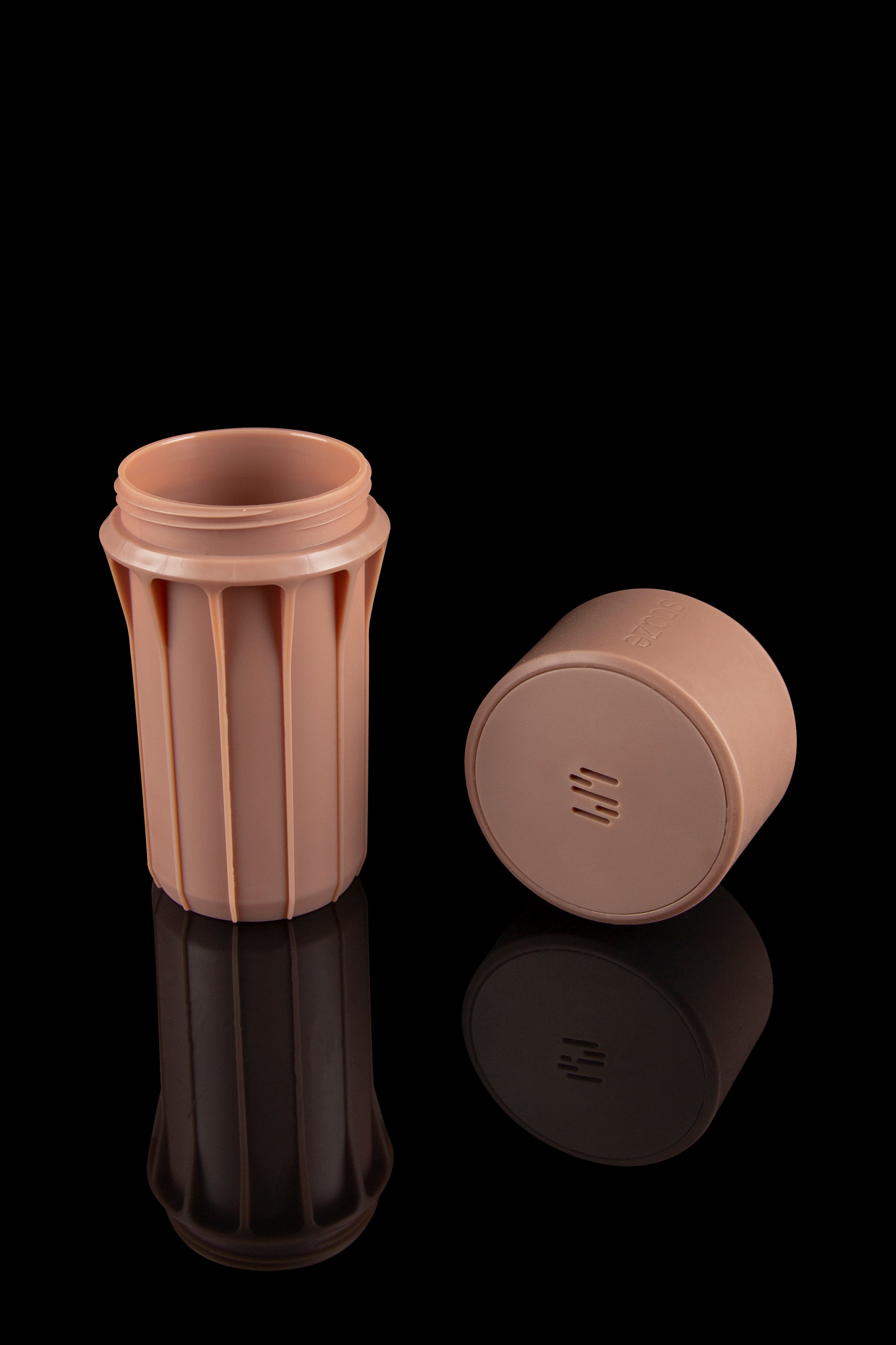 Empty, terracotta-colored silicone cannabis container with lid and reflective surface.