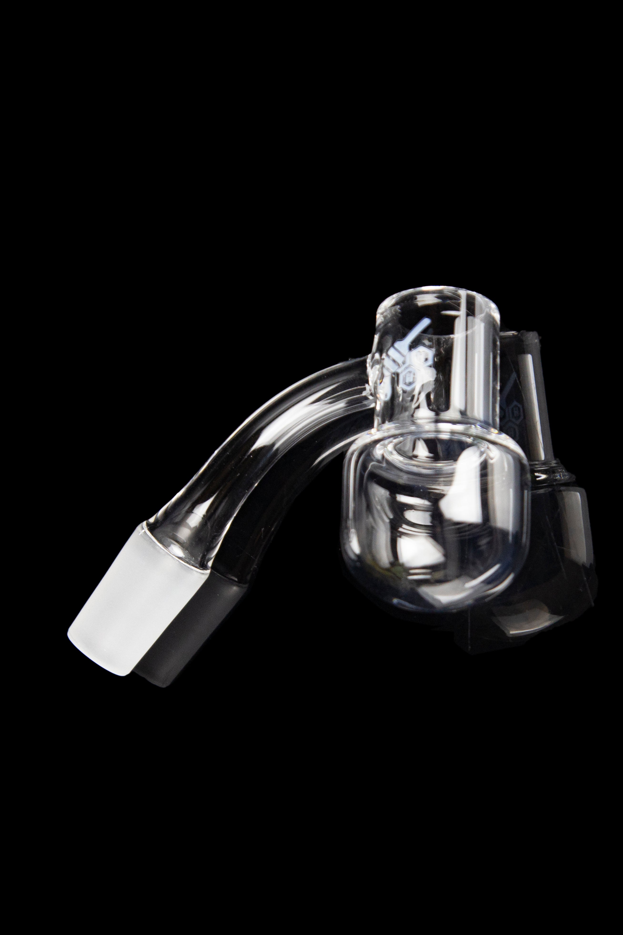 Clear glass dab rig attachment with intricate internal diffusion chambers, isolated on a black background.