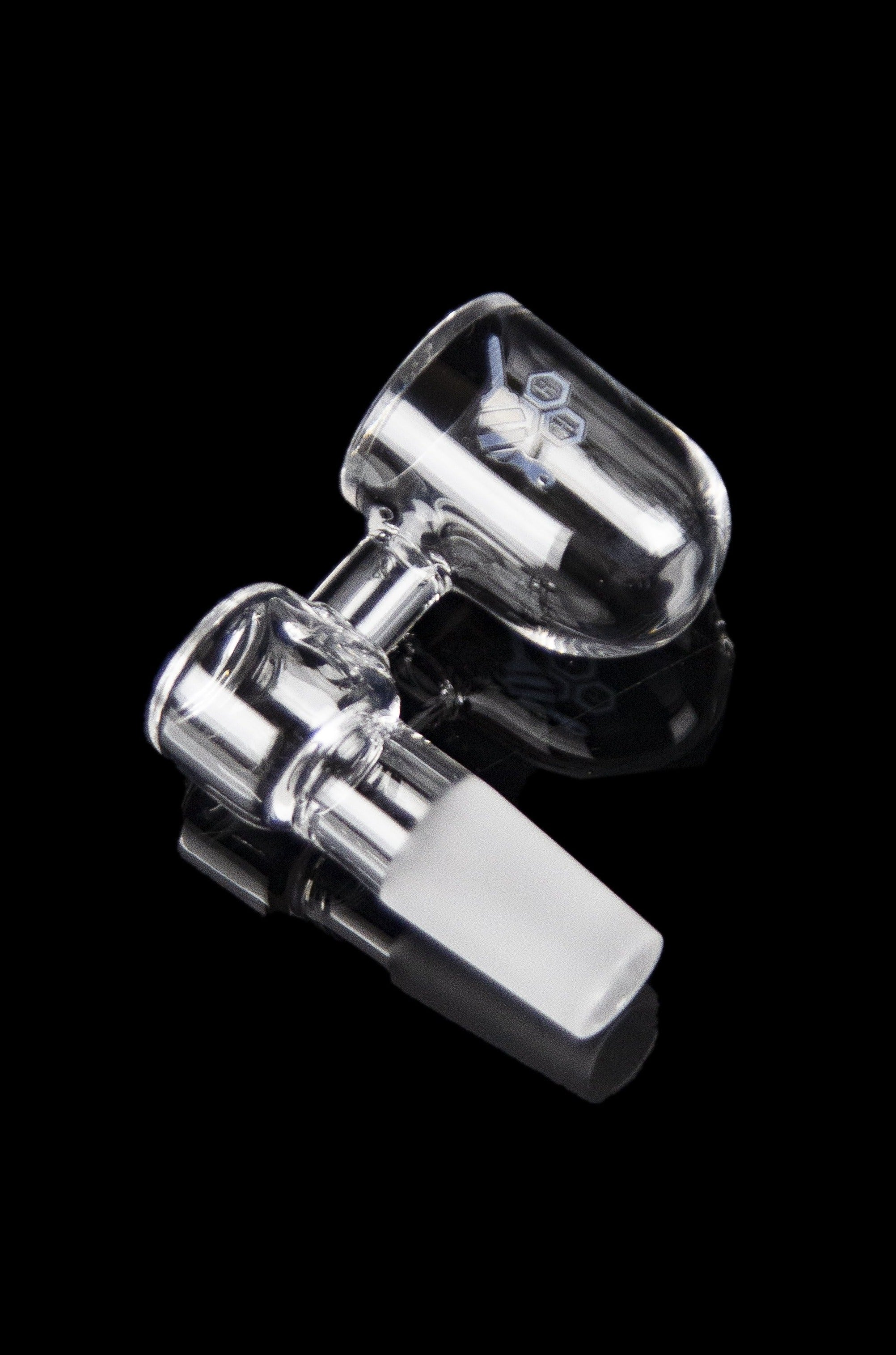 Clear glass dab rig with a quartz insert, isolated on a black background.