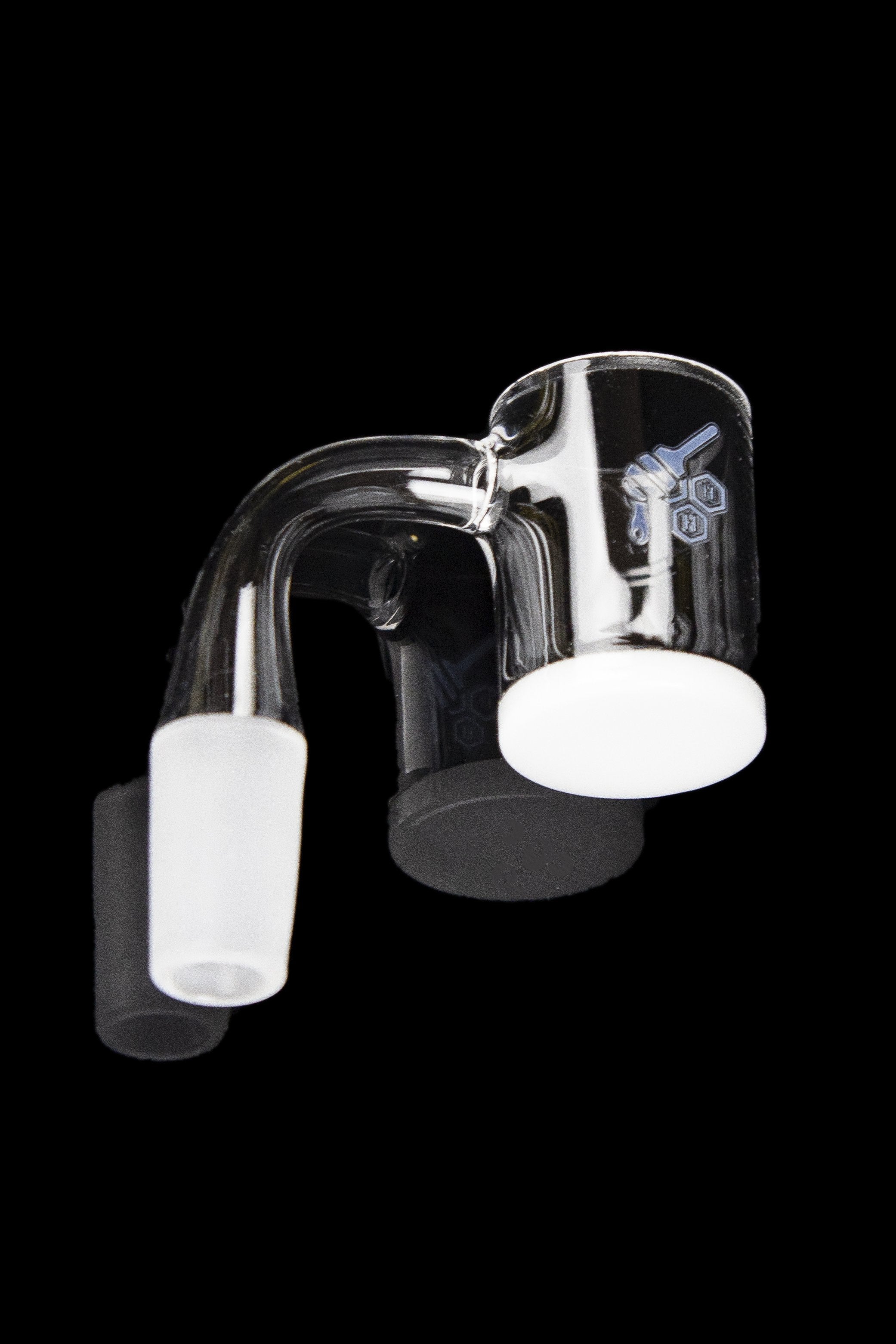 Clear glass dab rig with a quartz insert, isolated on a black background.