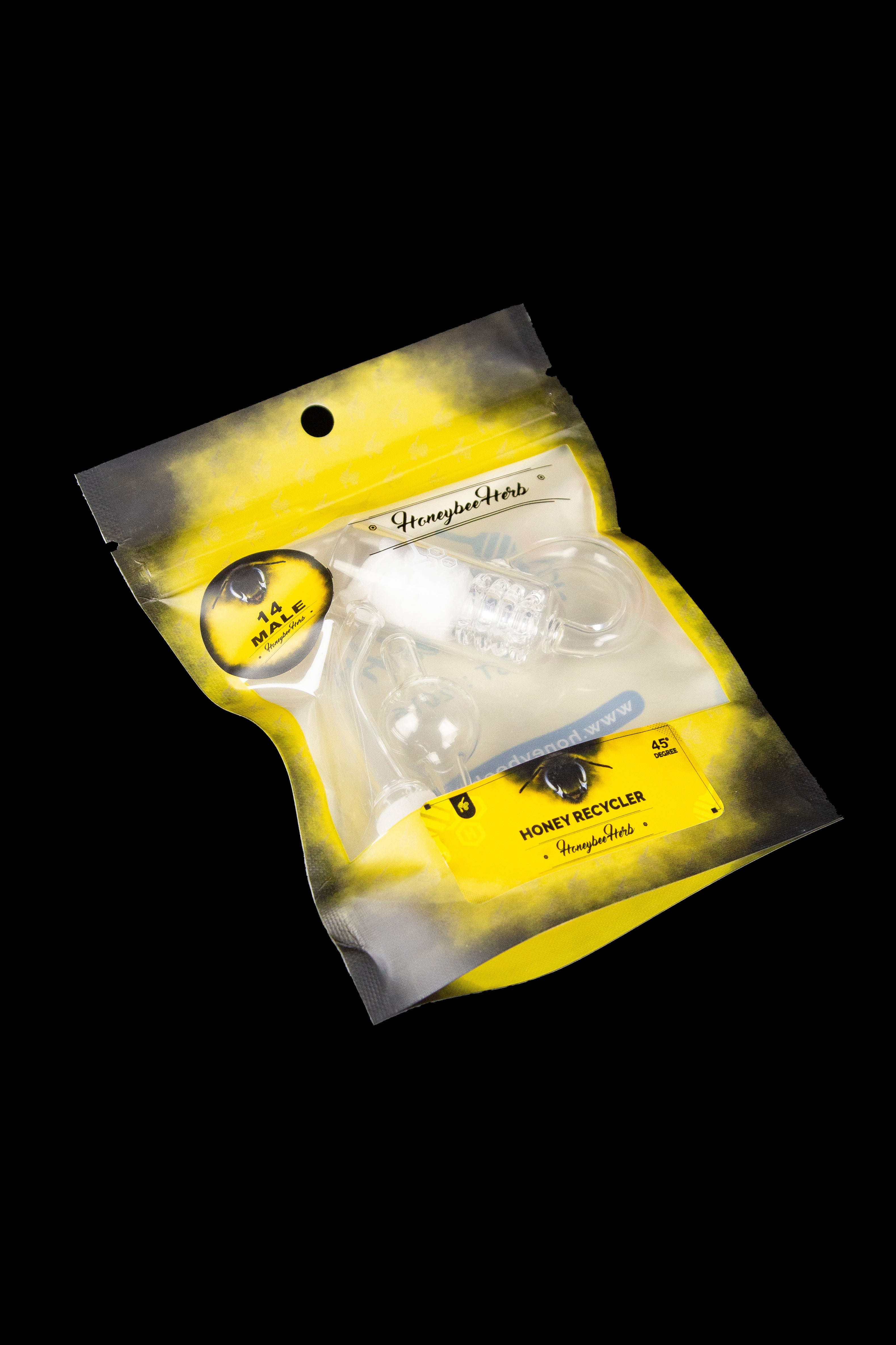 Sealed yellow mylar bag labeled “Honeybee Herbs” containing a glass cannabis oil recycler.