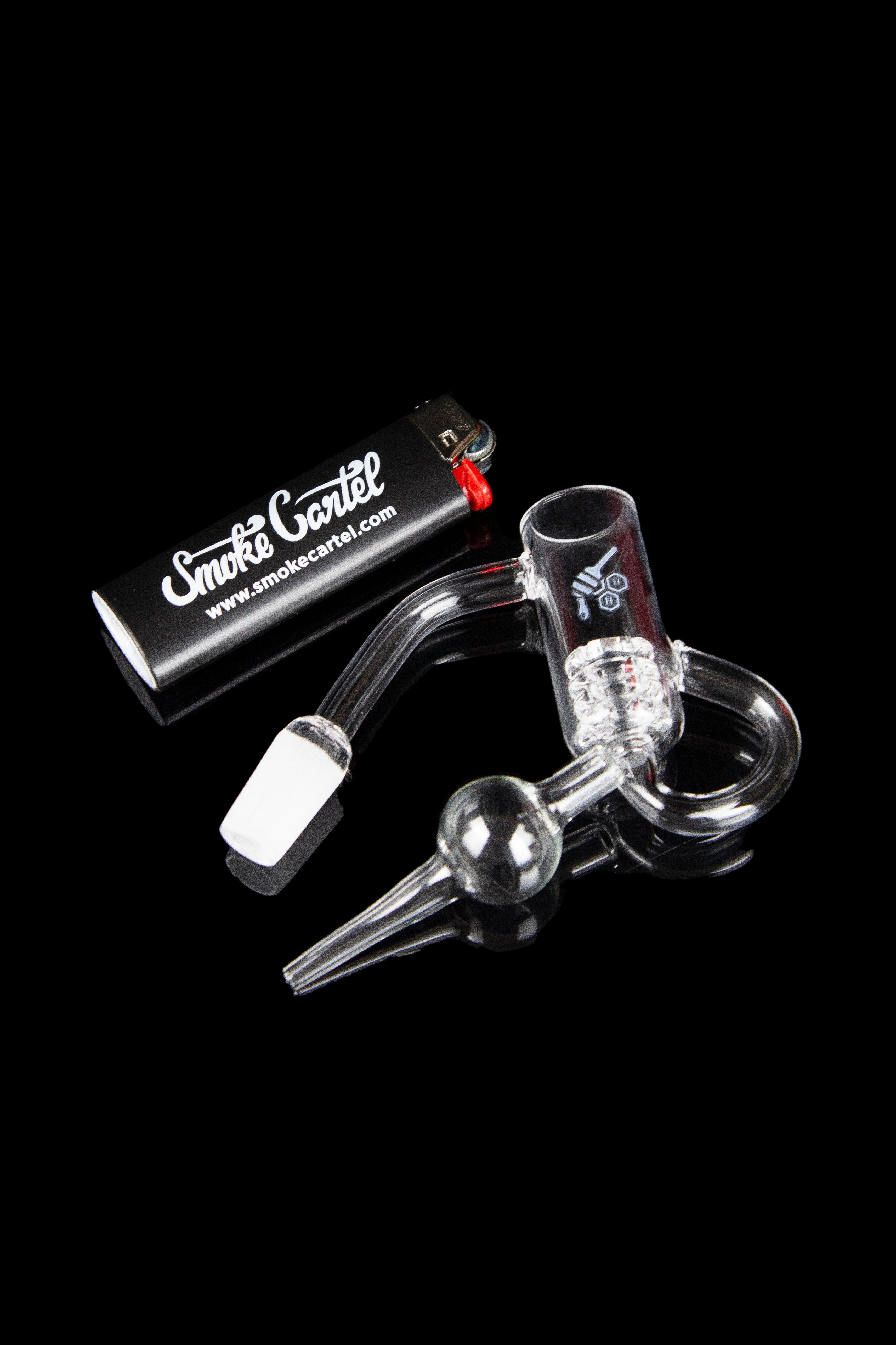 Glass oil rig with accessories and branded packaging.