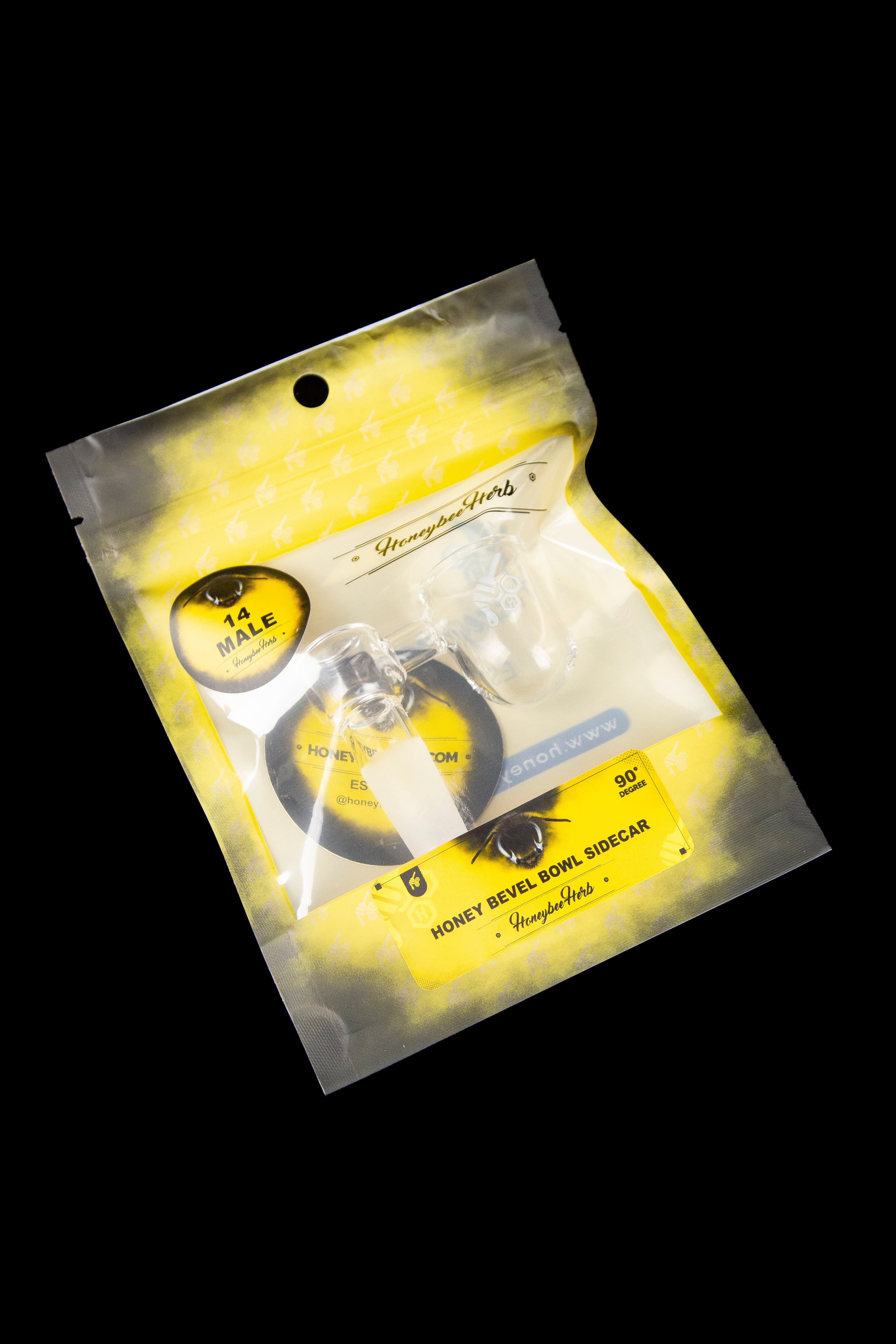 A sealed, metallic gold pouch displaying a black glass cannabis bowl accessory called “Honey Bevel Sidecar” with a 90-degree angle.