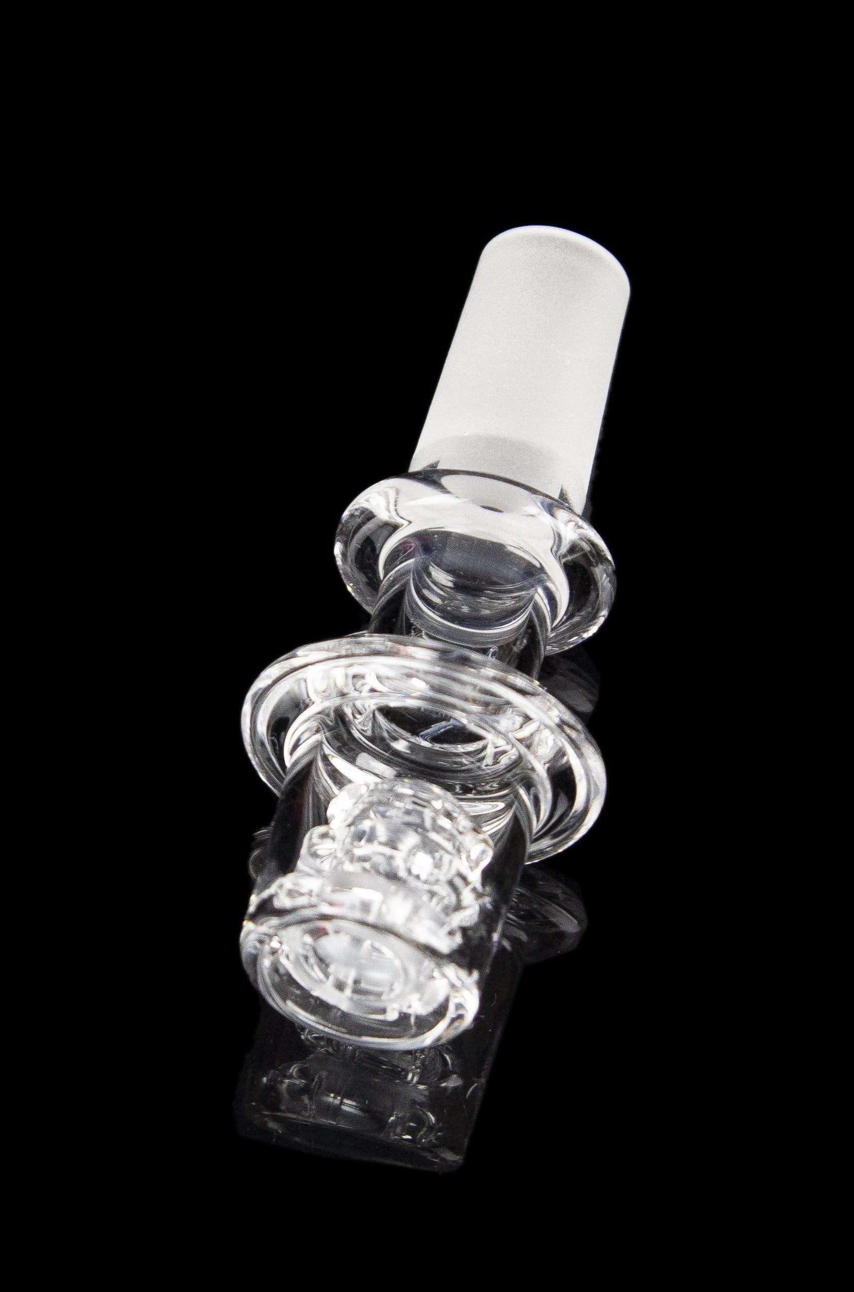 Clear glass cannabis oil rig bubbler with intricate sculpted design.