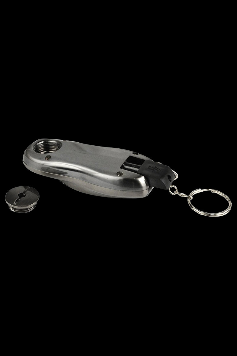 A slightly angled close-up of the Stealth "Car Key Fob" Secret Hand Pipe, showing its metallic finish and key-chain attachment.