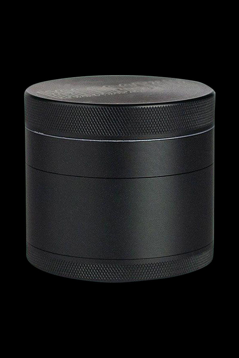 A close-up, angled view of the Kannastor 4-Piece Solid Body Grinder, showing its metallic finish and multi-tiered construction.