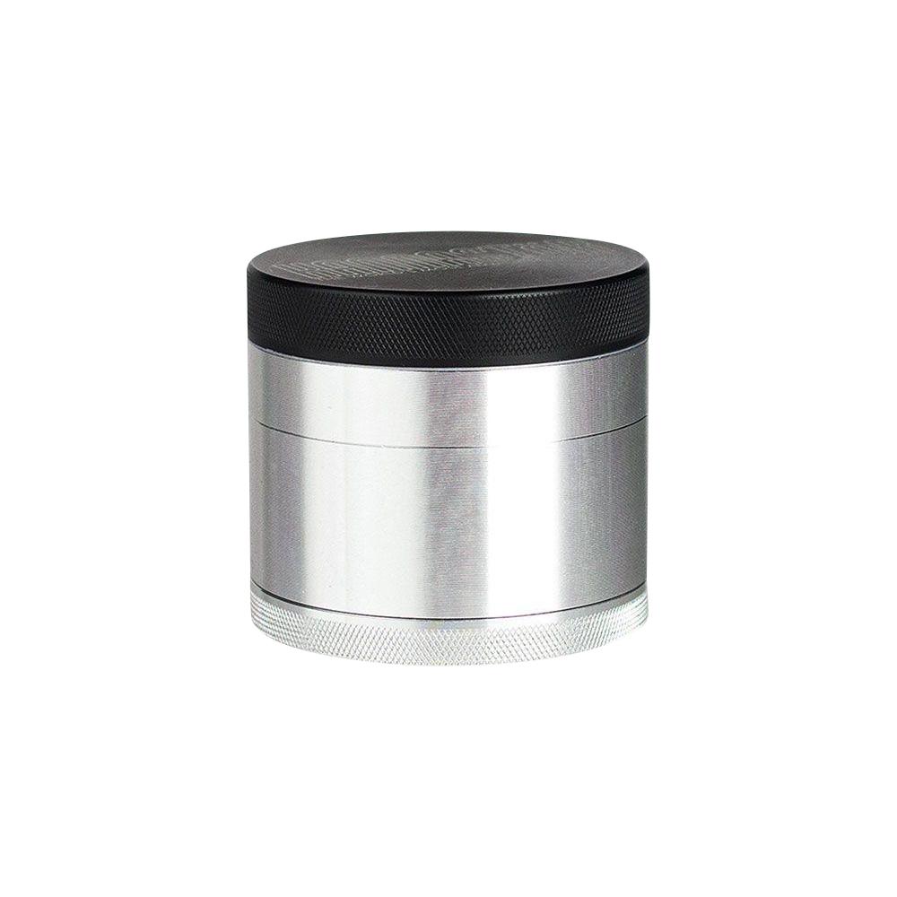 A close-up, angled view of the Kannastor 4-Piece Solid Body Grinder, showcasing its metallic finish and multi-tiered construction.