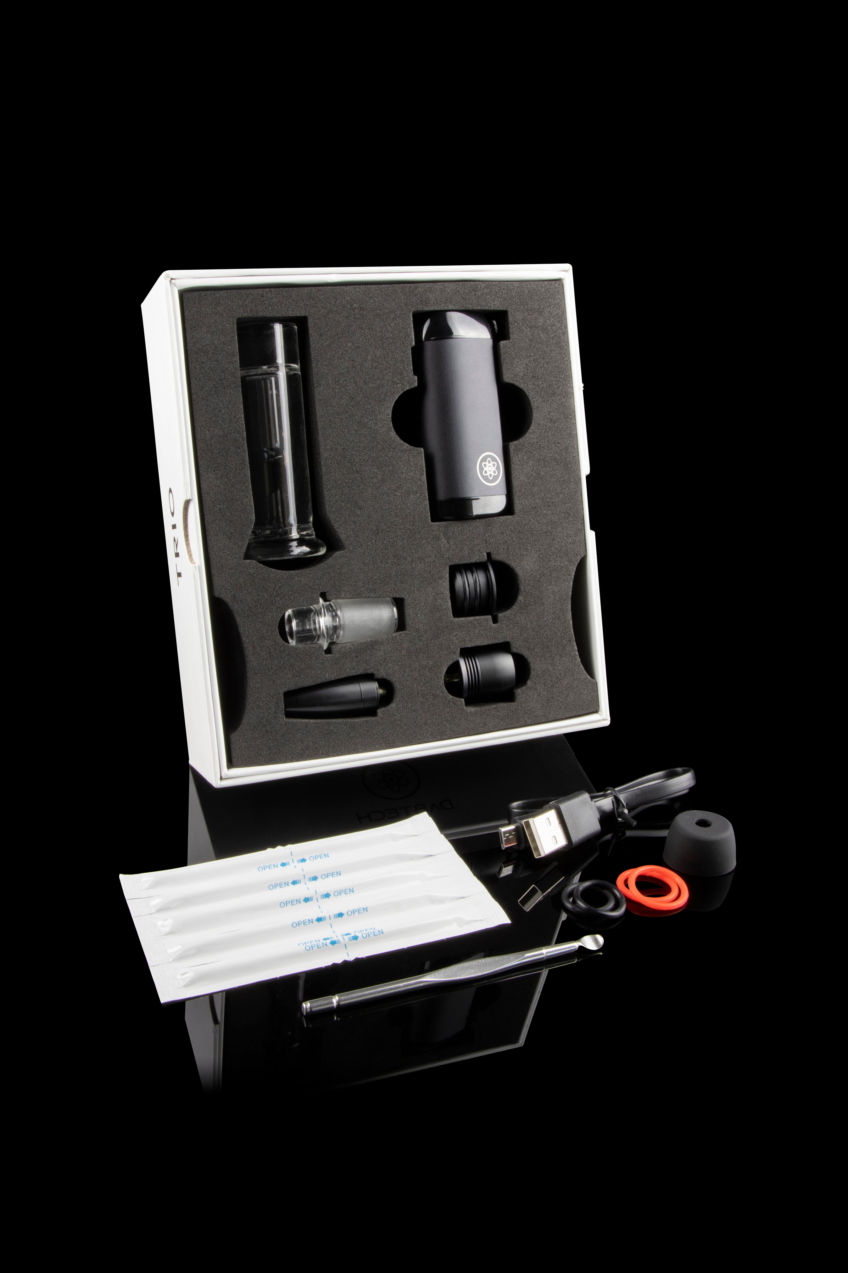 Cannabis vaporizer kit with device, attachments, cleaning tools, and replacement pads displayed in a foam insert.