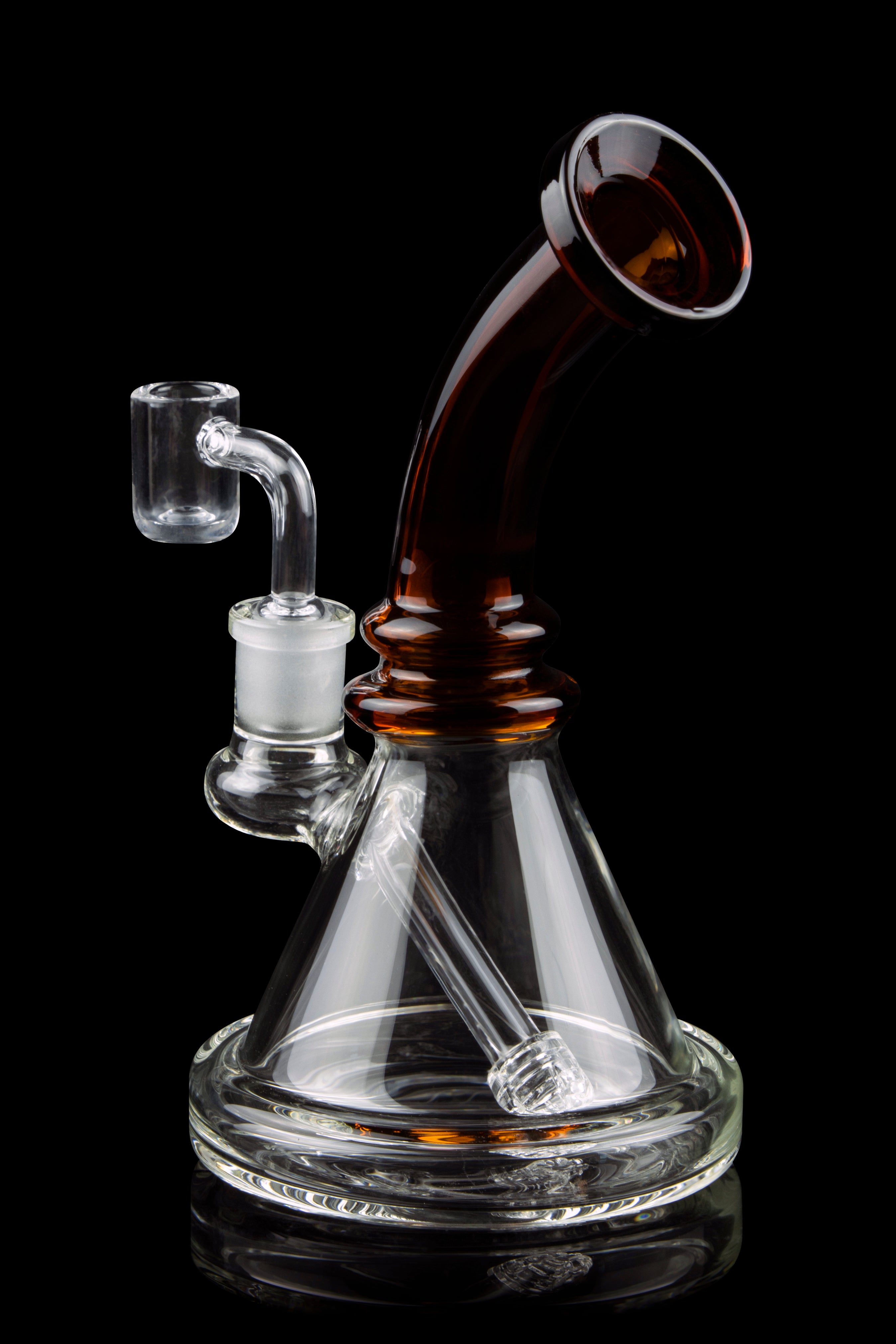Clear glass water pipe (rig) with amber accents and a quartz banger, isolated on a black background.