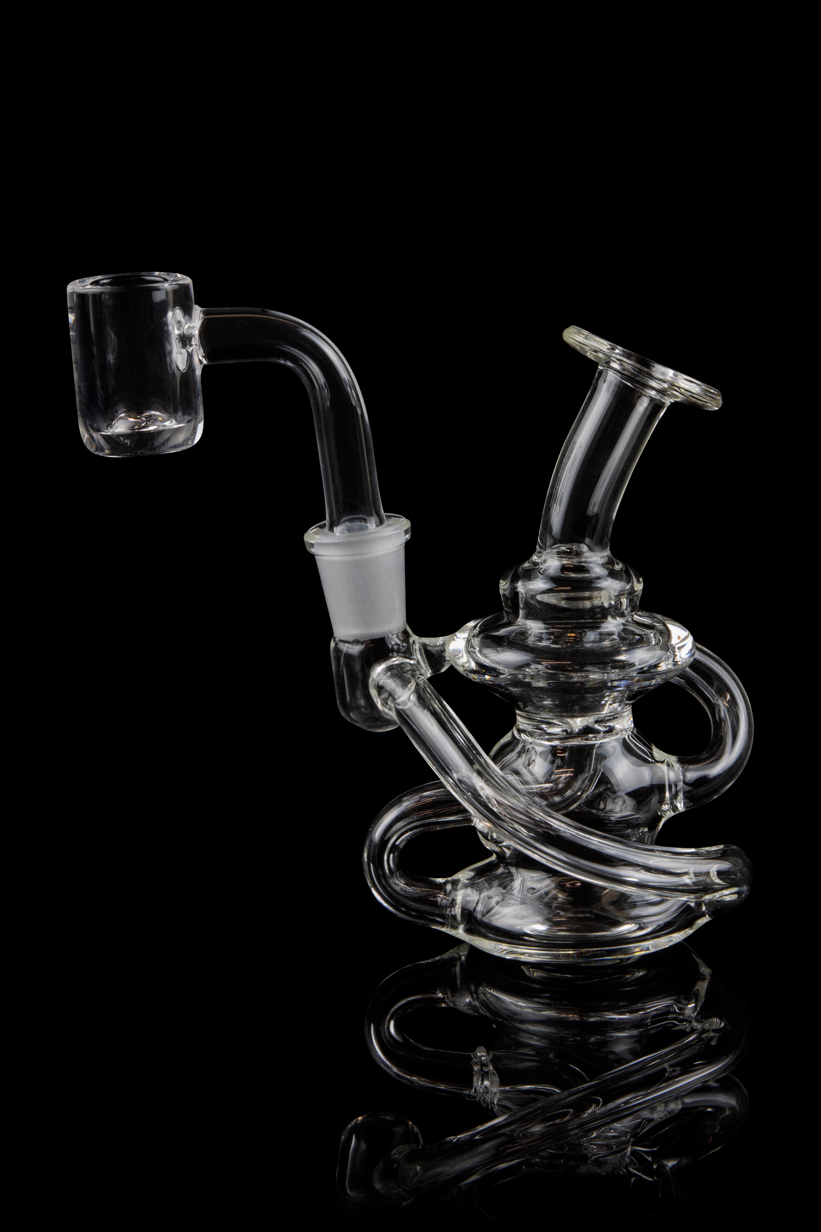 Clear glass dab rig with intricate looping design and quartz banger, isolated on black.