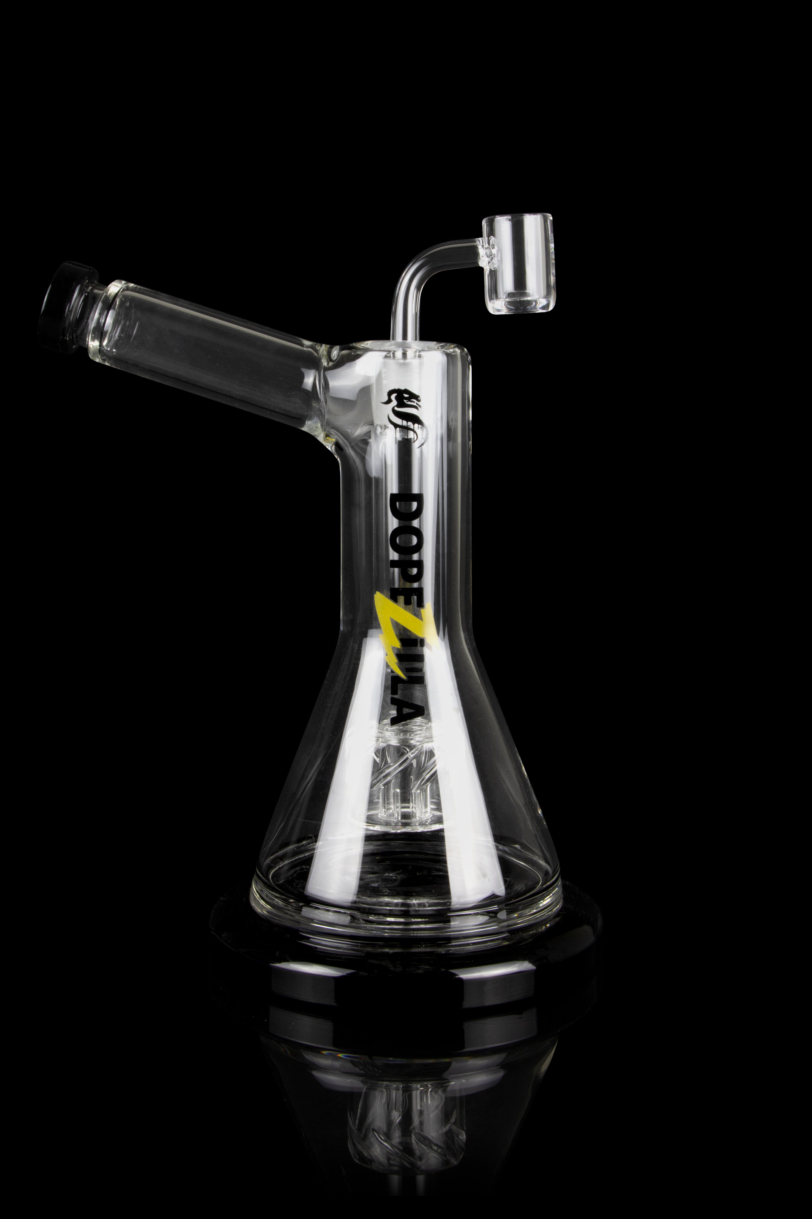 Clear glass oil rig with a dab nail and intricate internal diffusion, reflecting on a black surface.