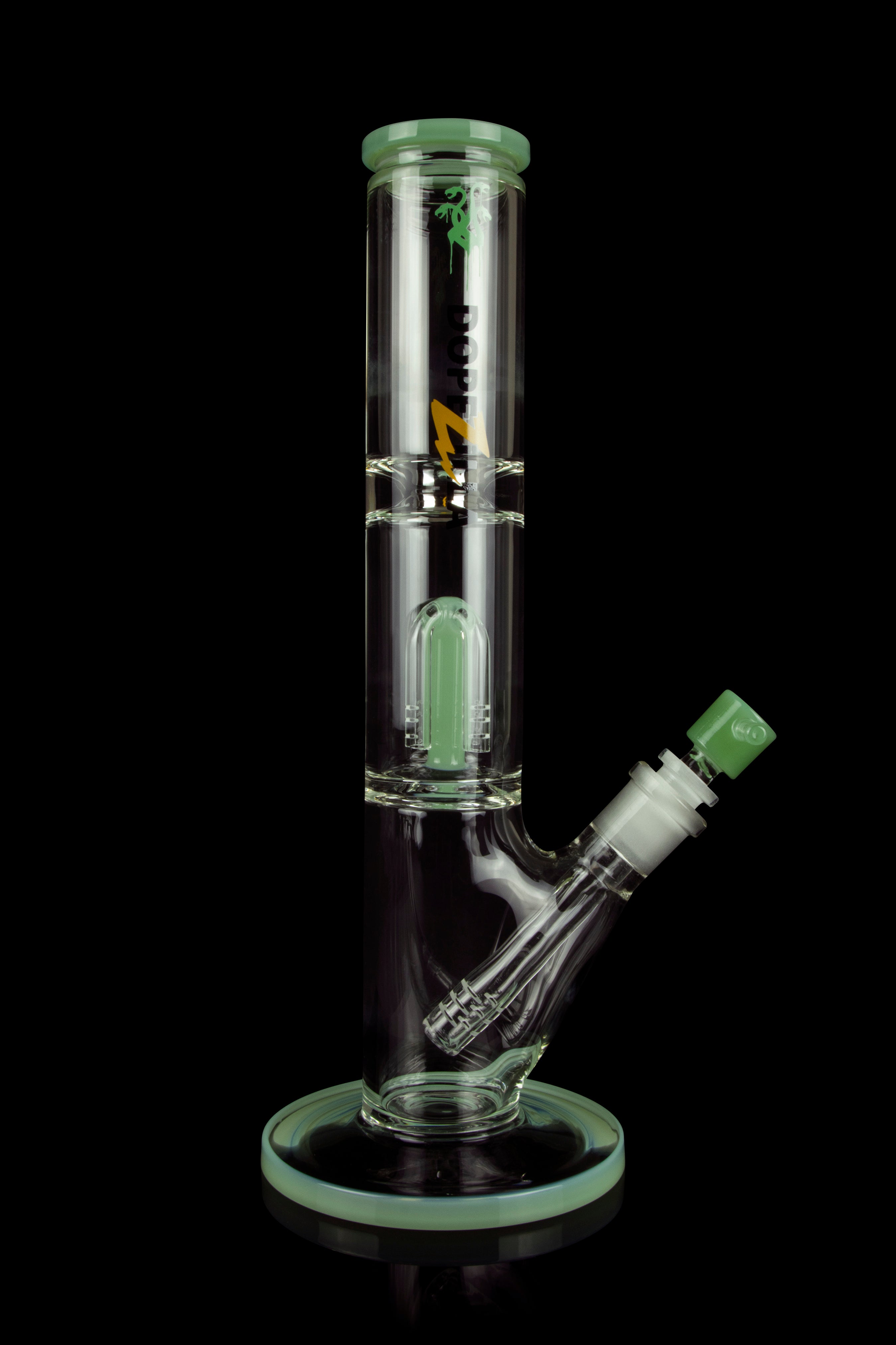 Green glass water pipe (bong) with intricate design, studio shot.