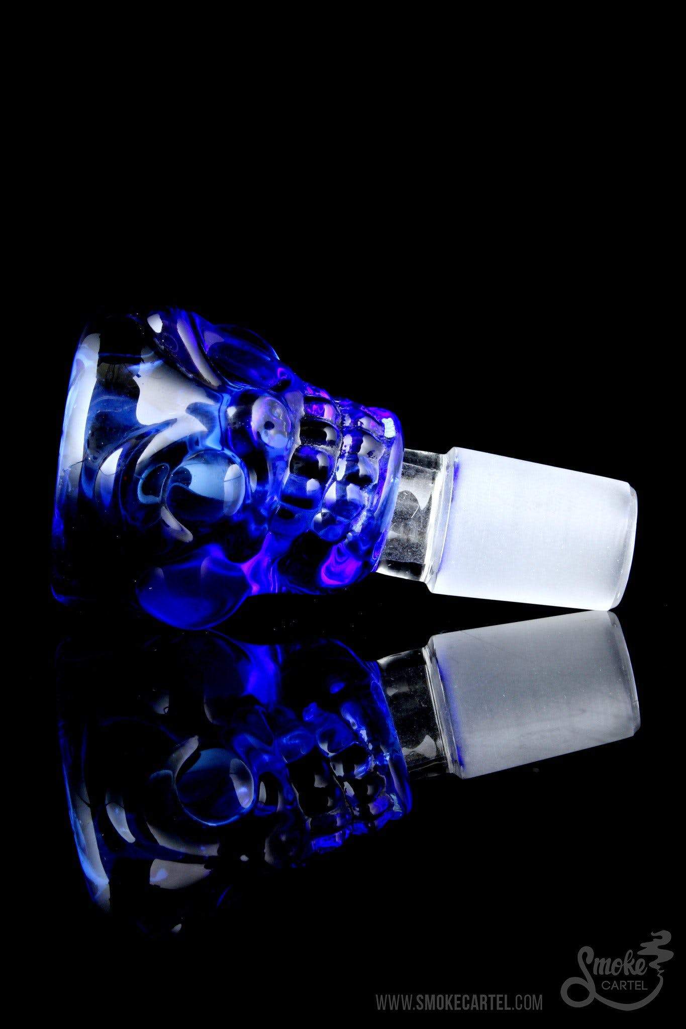 A detailed side view of “The Skull” Bowl Slide, featuring a translucent blue glass design with intricate skull detailing.