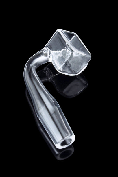 A three-quarter view of the Cube Quartz Banger, showcasing the clear quartz material and its reflective surface on a dark background.